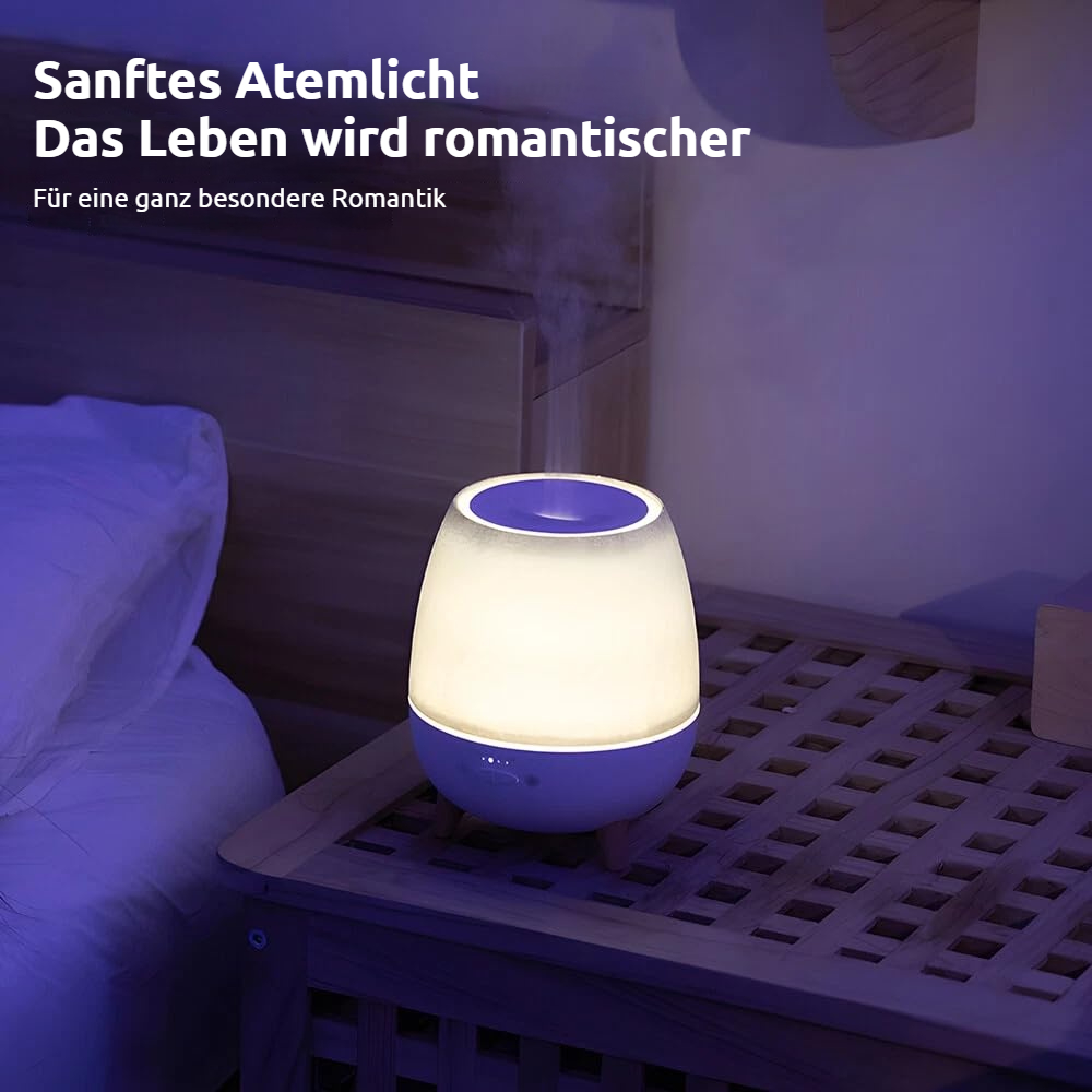 Ein weißer und blauer Diffusor für ätherische Öle steht auf einem Nachttisch neben einem Bett.