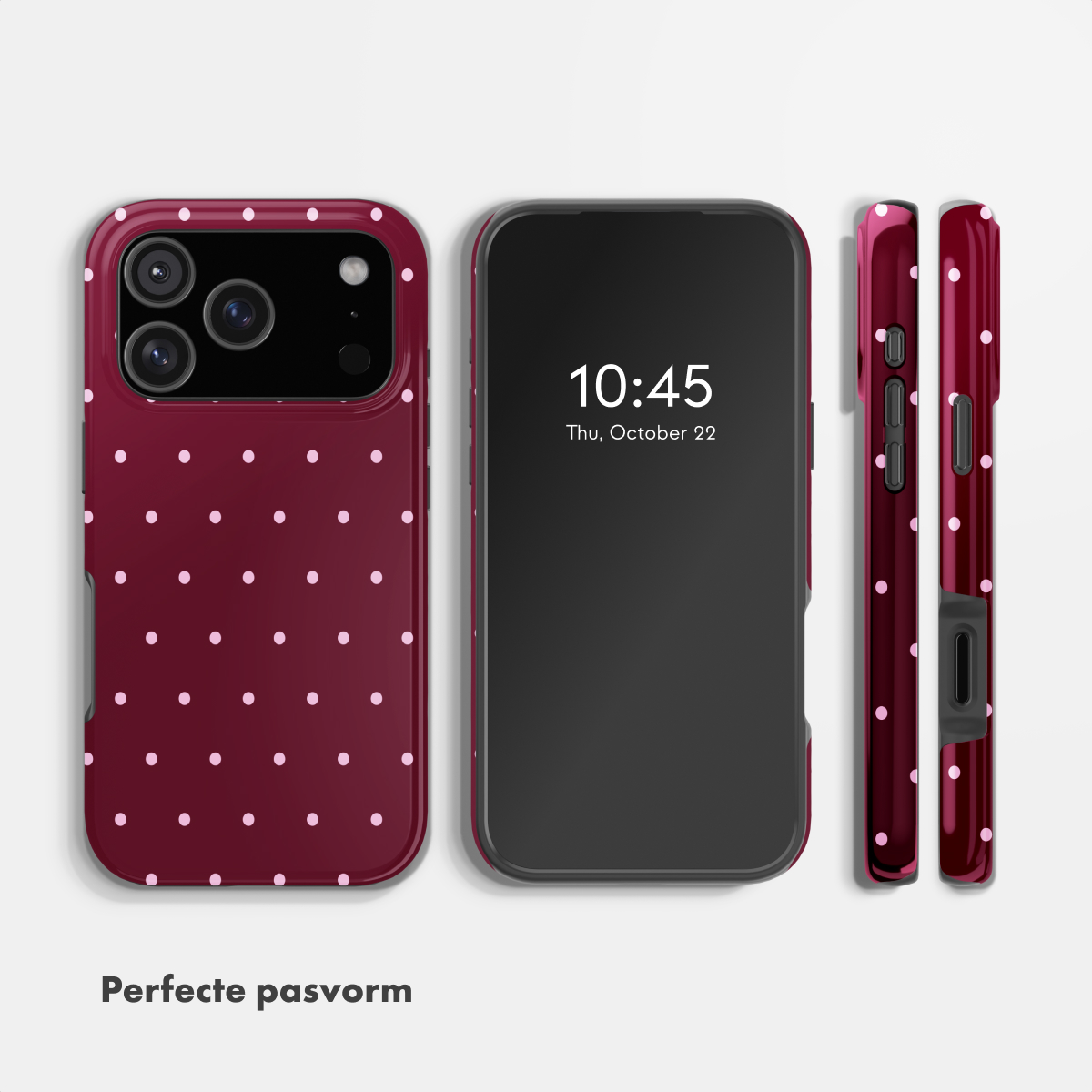 A burgundy phone case with pink polka dots, next to a smartphone.