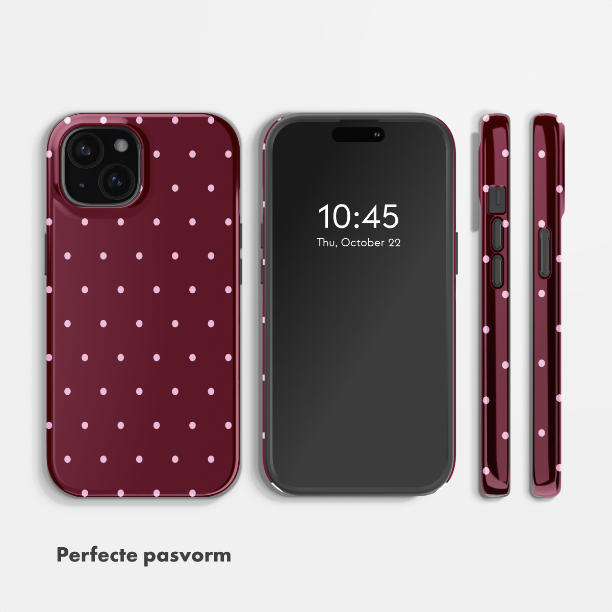 Een donkerrode telefoonhoes met roze stippen en ernaast een smartphone.
