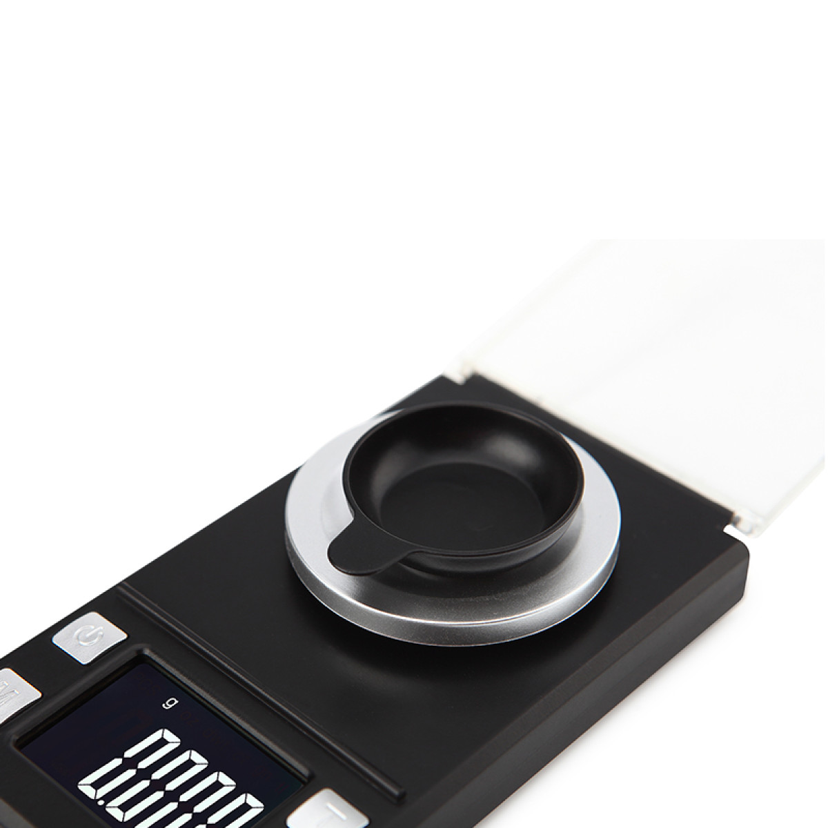 Eine schwarze Digitalwaage mit einer kleinen Schale, die auf der Wiegeplattform steht.