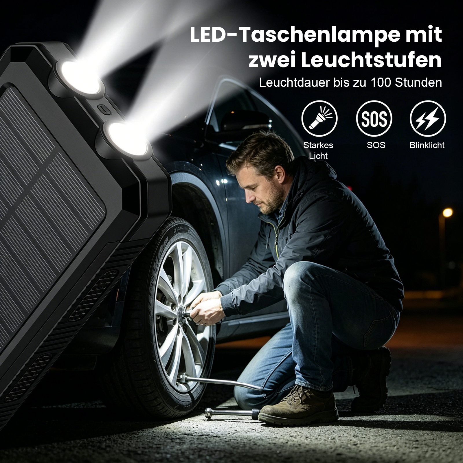Mann wechselt Reifen bei Nacht, beleuchtet von einer LED-Taschenlampe.