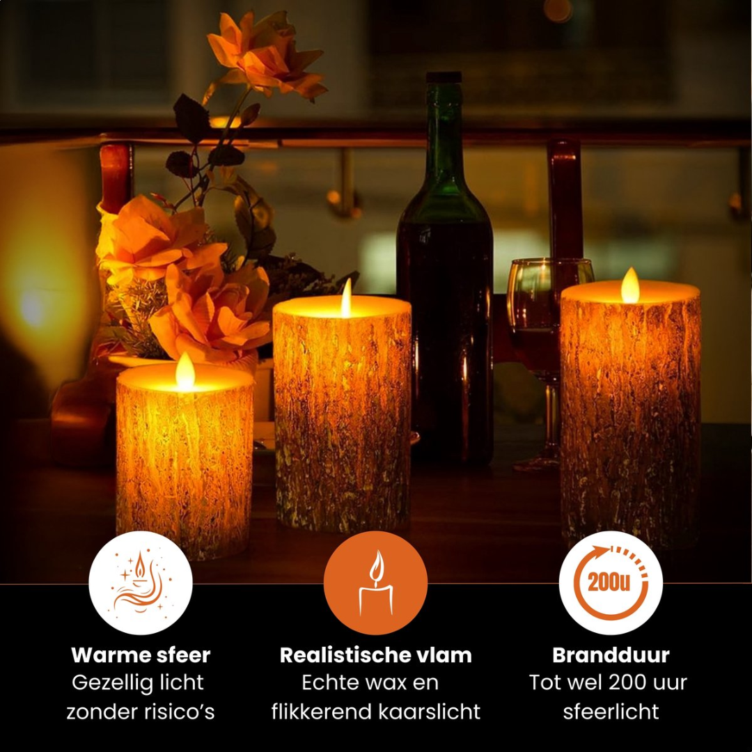 Three LED candles with realistic flames stand on a table, next to a wine bottle and flowers.