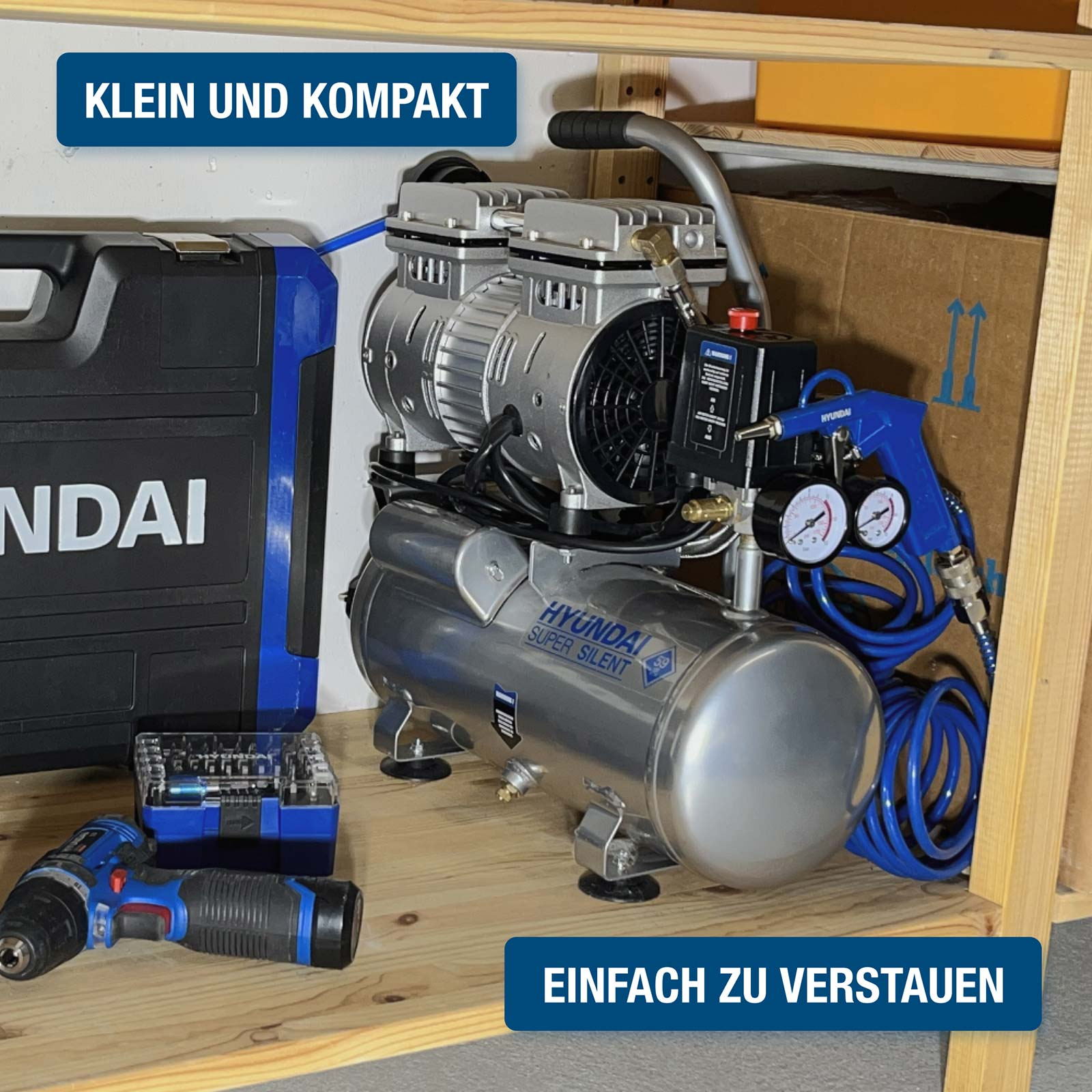 Ein silberner HYUNDAI Kompressor mit Zubehör, darunter ein Werkzeugkasten und ein Akkuschrauber.