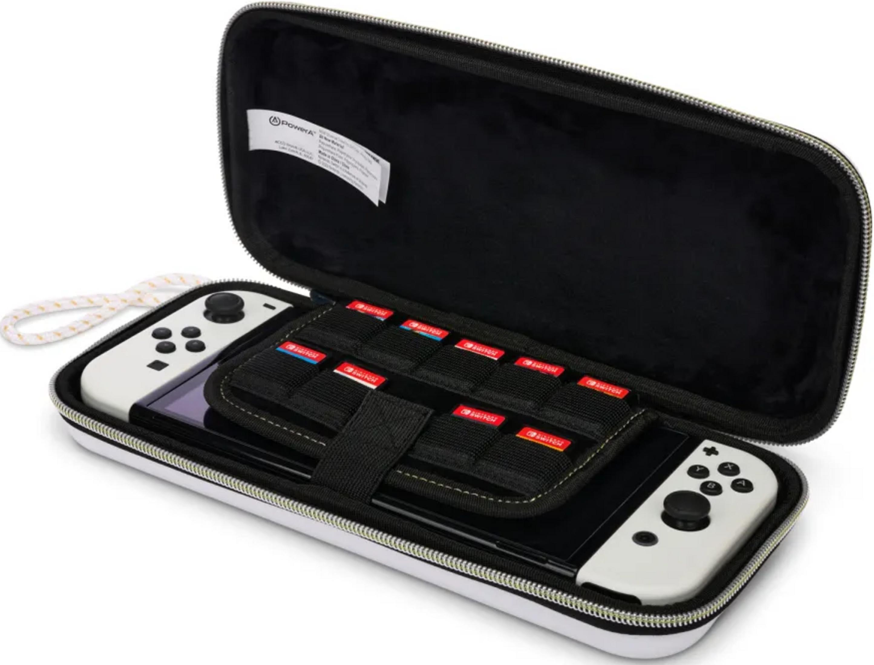 Białe etui z konsolą Nintendo Switch, dwoma białymi kontrolerami i kartridżami.