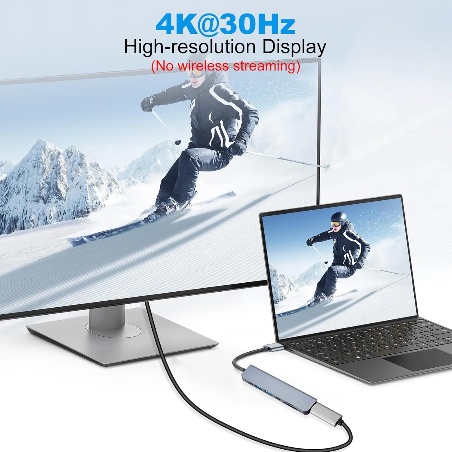 Ein Laptop und ein Monitor zeigen einen Skifahrer. Ein USB-C-Hub verbindet sie.