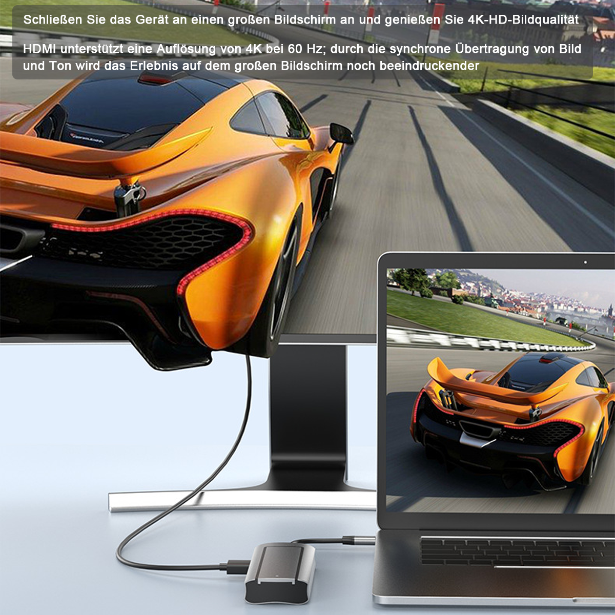 Ein orangefarbener Sportwagen wird auf einem großen Bildschirm und Laptop angezeigt.