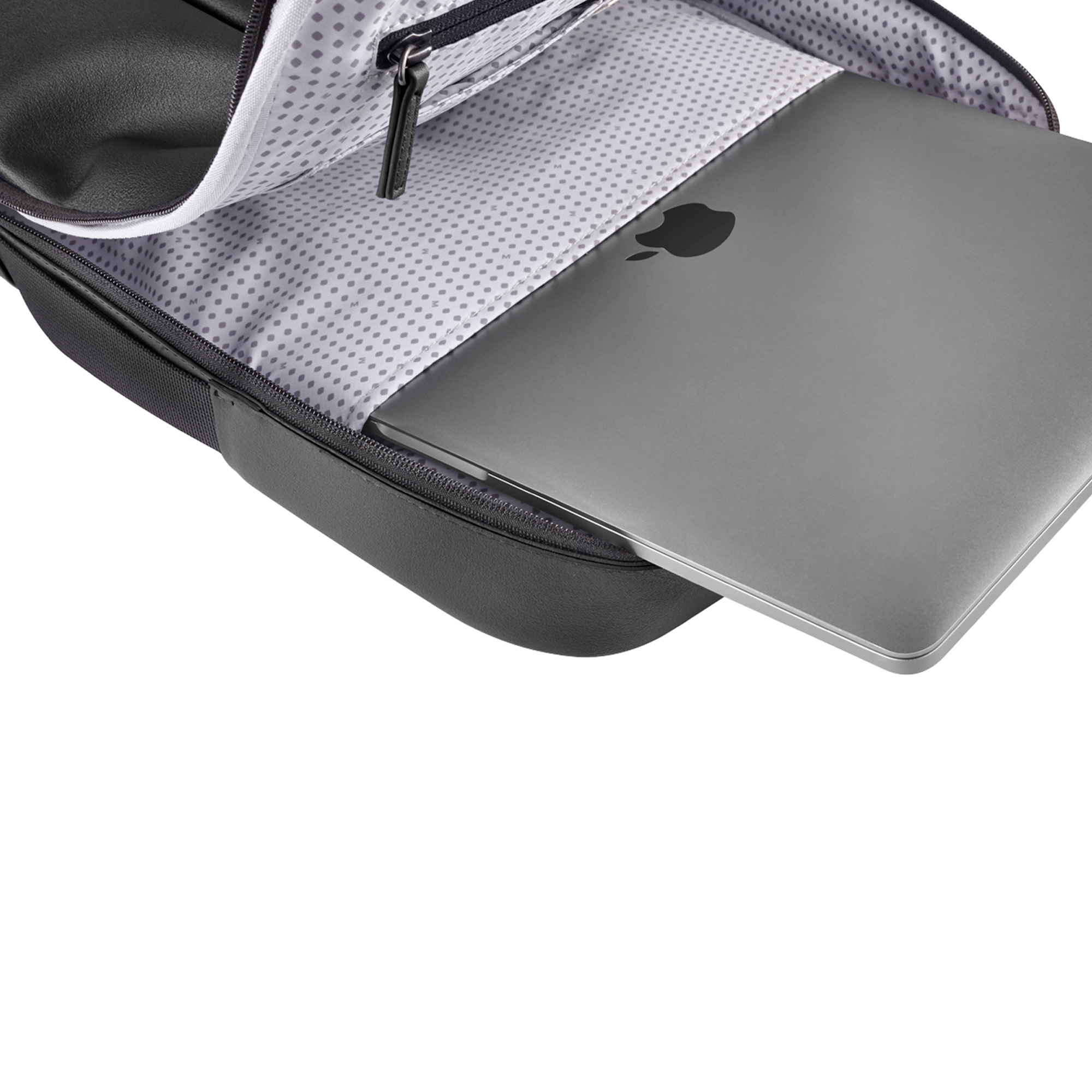 Un MacBook Apple grigio giace all'interno di uno zaino nero aperto con fodera fantasia.