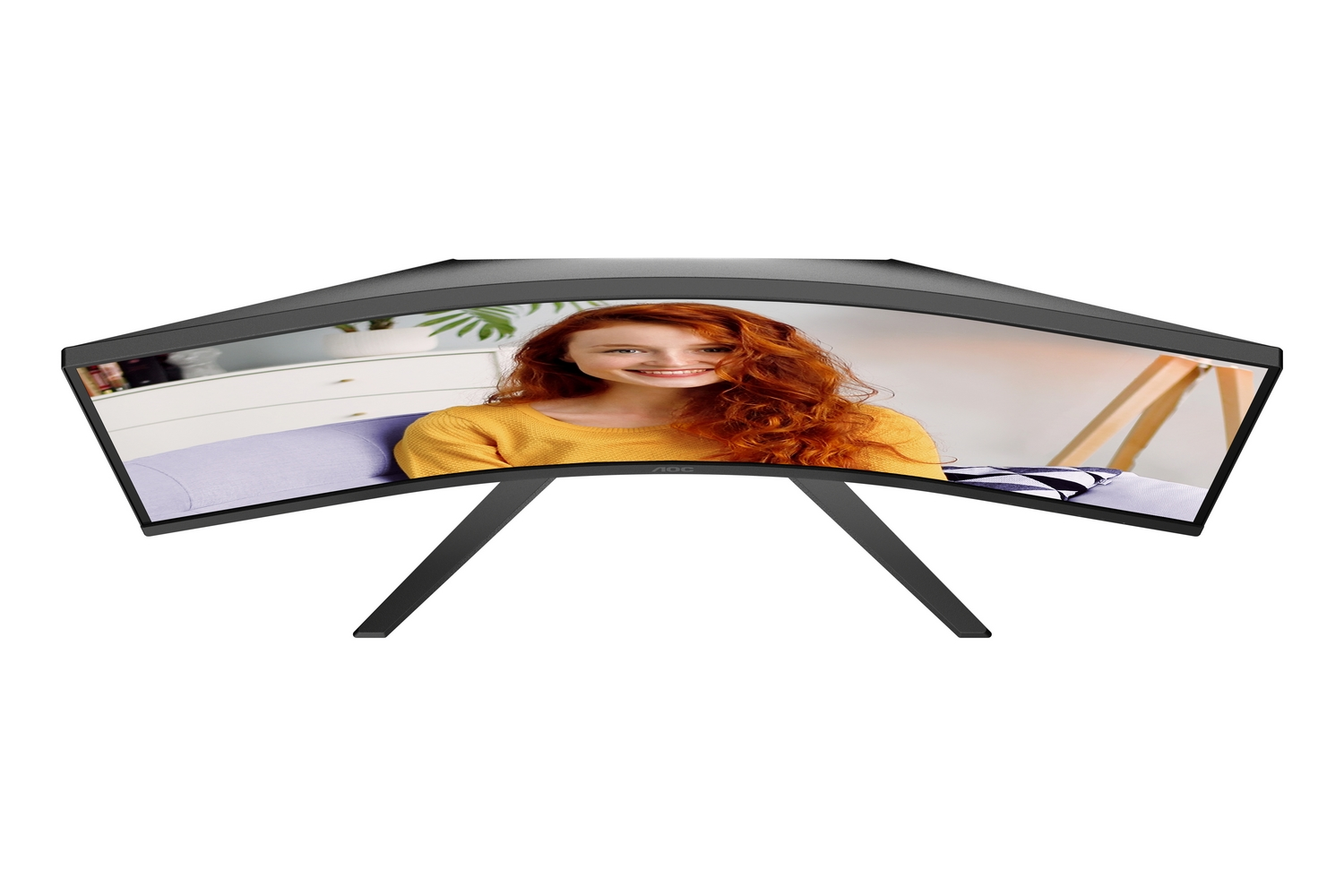 Monitor curvo que muestra a una pelirroja sonriente con suéter amarillo.