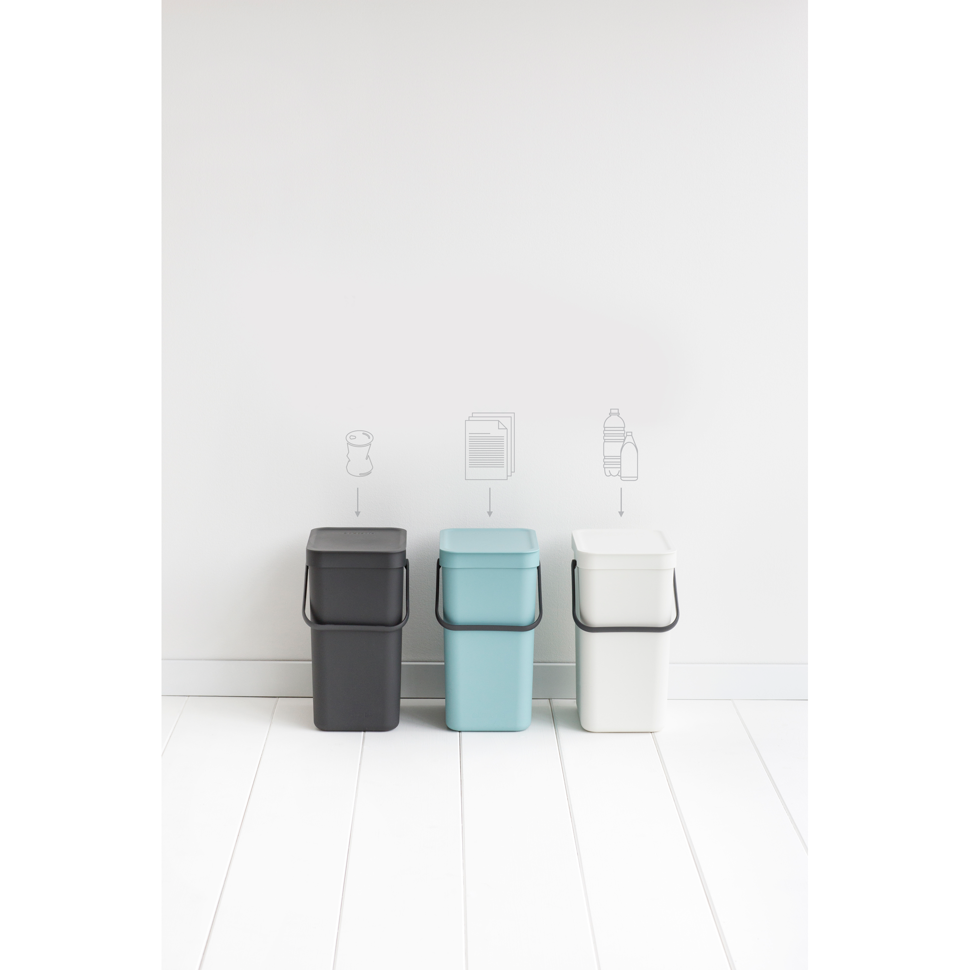 Three bins: dark grey, blue, and white, with icons for waste, paper, and bottles.