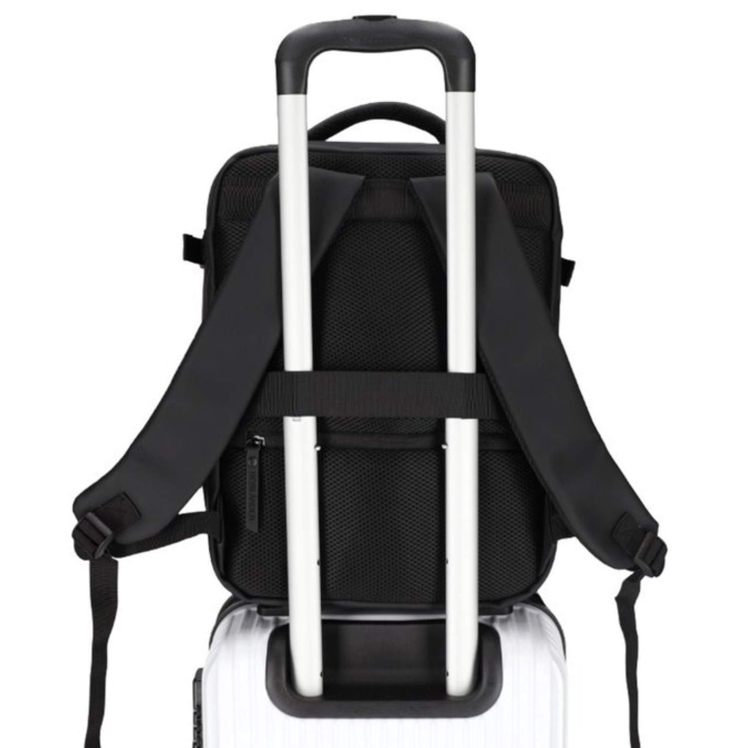A black backpack is attached to a white rolling suitcase.