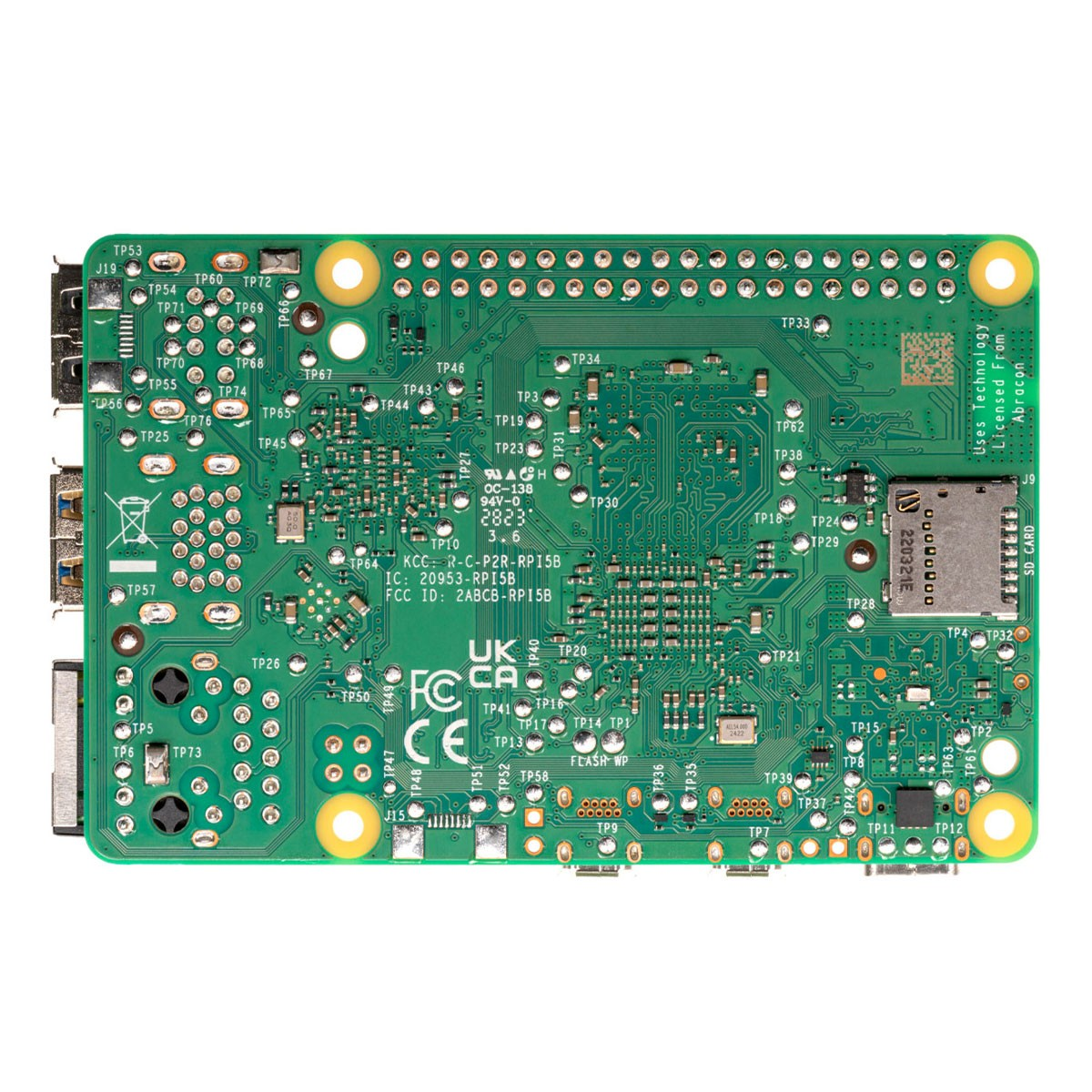 Scheda a circuito stampato verde con molti punti di test, chip e uno slot per schede SD.