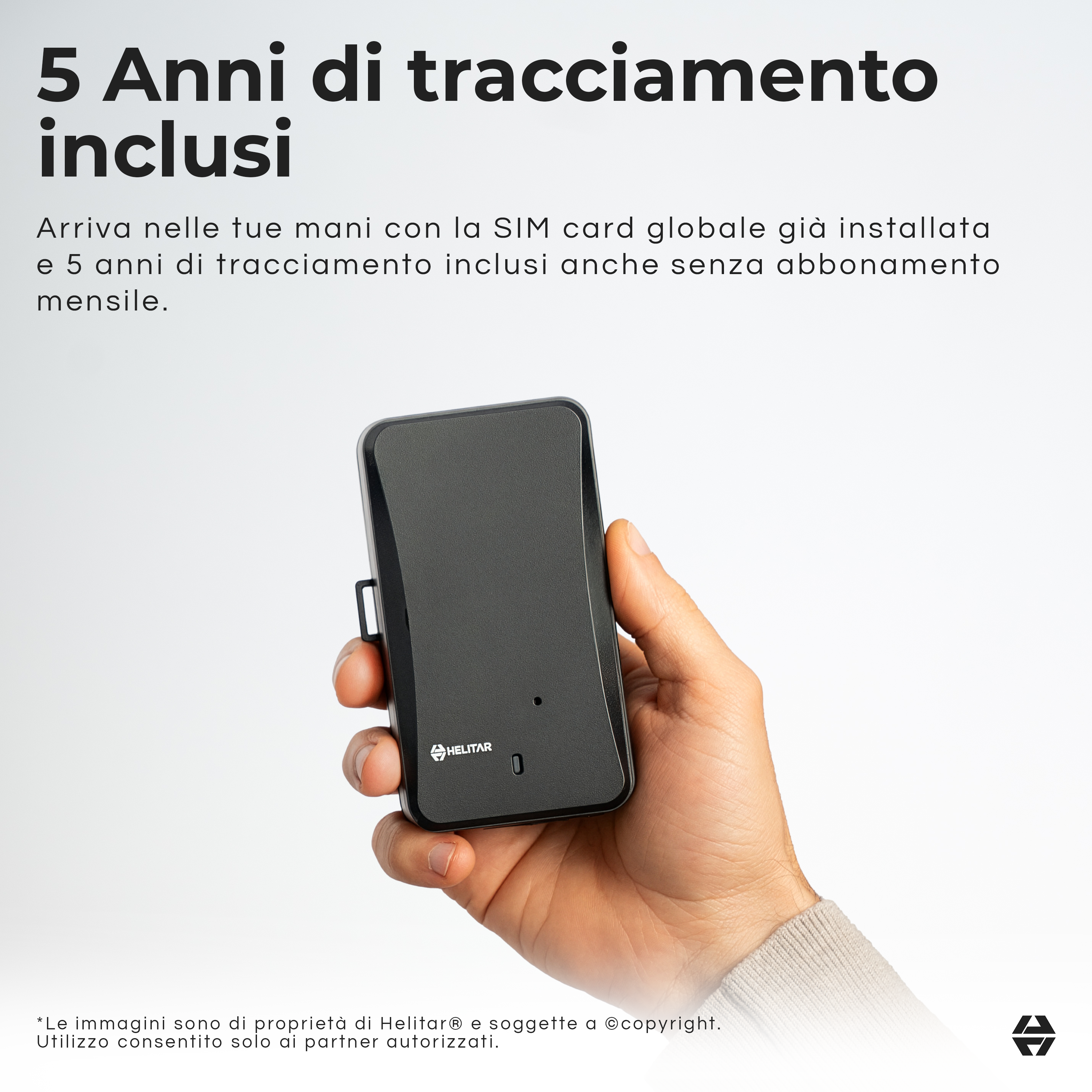 Una mano tiene un dispositivo di tracciamento nero con il logo Helitar.