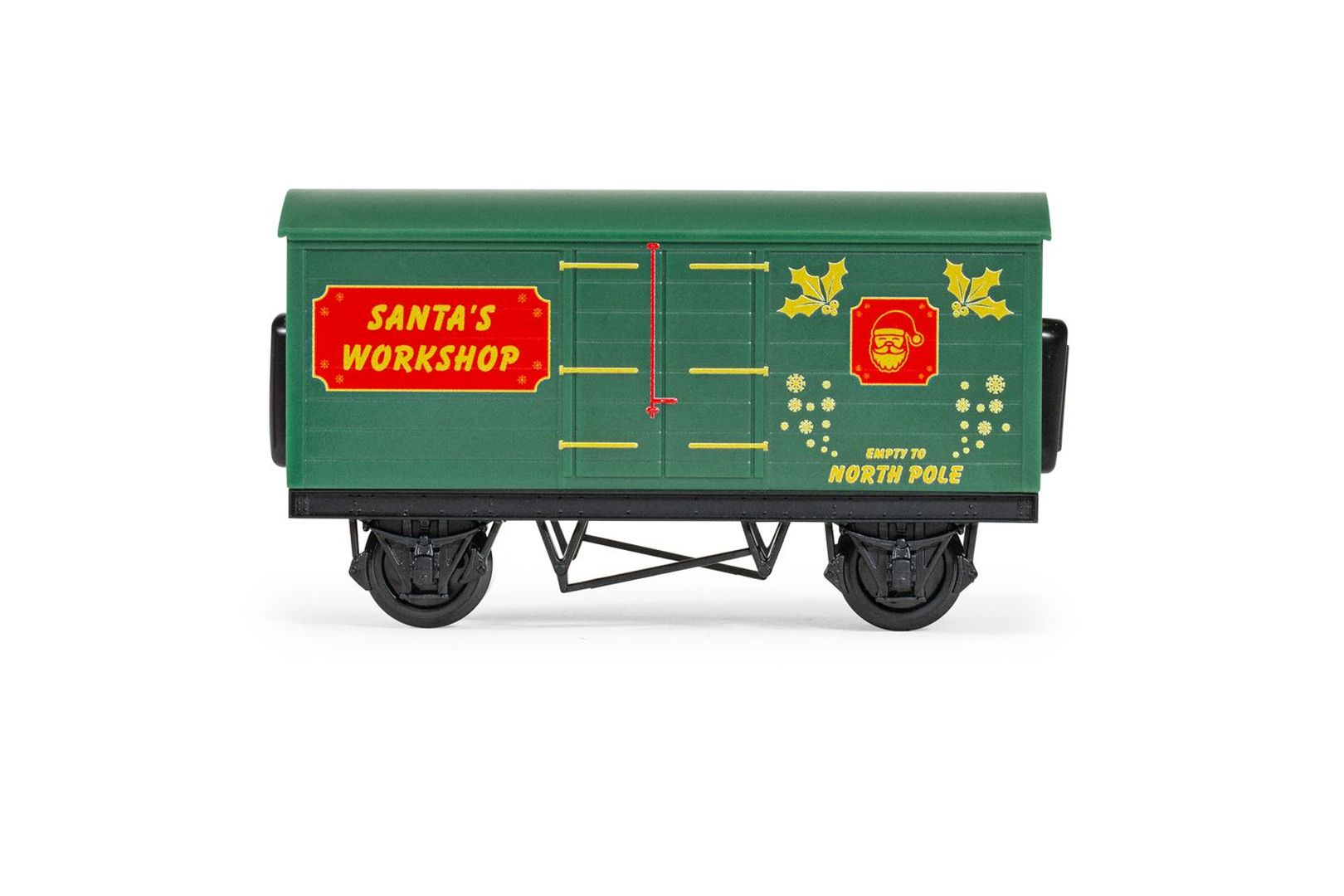 Zielony wagon kolejowy z napisem 'SANTA'S WORKSHOP' i grafiką Świętego Mikołaja.