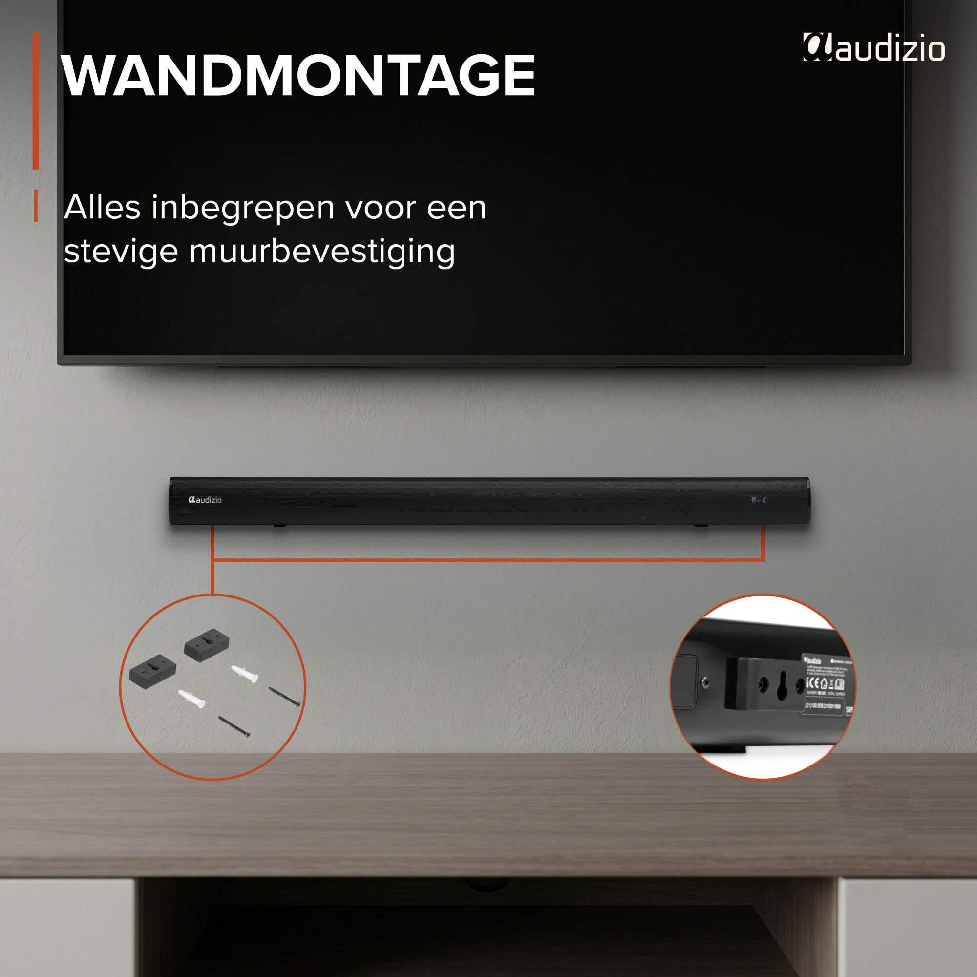 Una barra de sonido negra se monta en la pared, se muestran accesorios.