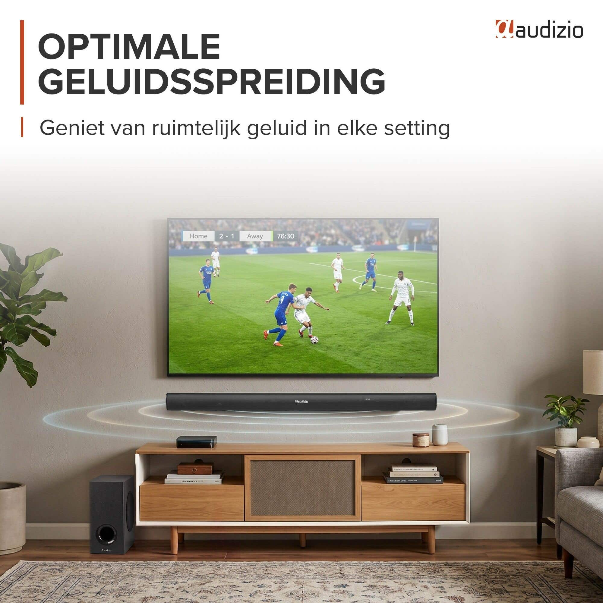 Un televisor muestra un partido de fútbol, con una barra de sonido y subwoofer debajo.