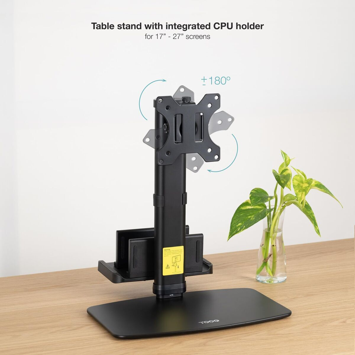 Ein schwarzer Monitorständer mit integriertem CPU-Halter steht auf einem Holztisch.