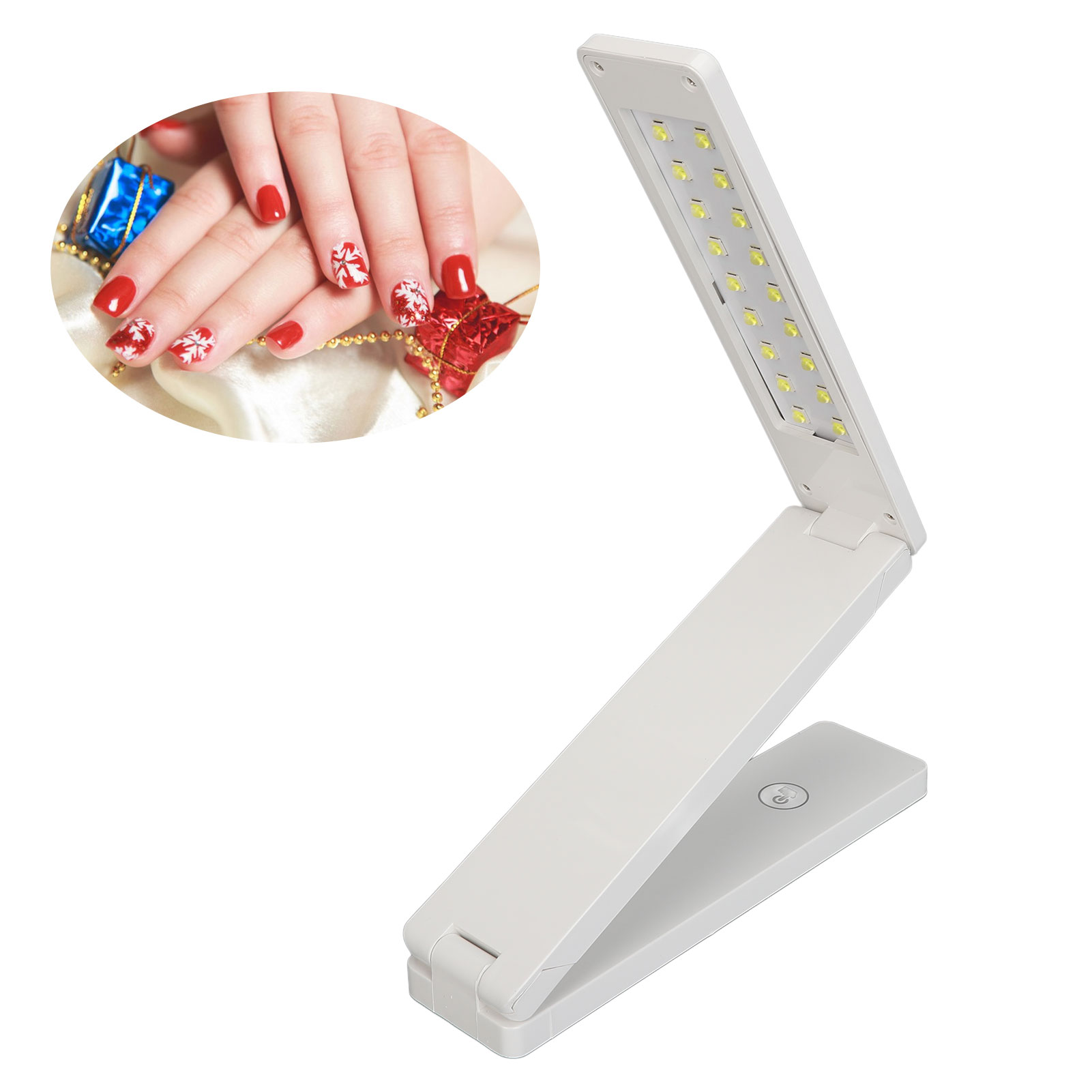 Ein weißer LED-Nageltrockner steht neben einer Nahaufnahme von Händen mit roten Nägeln und Schneeflockendesign.