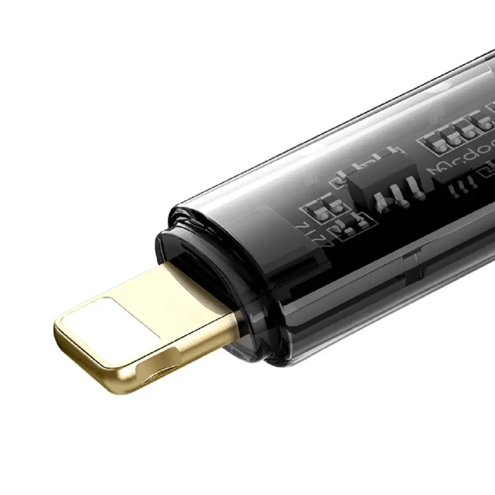 Altın rengi lightning konektörlü ve görünür devre kartlı şeffaf siyah adaptörün yakın çekimi.