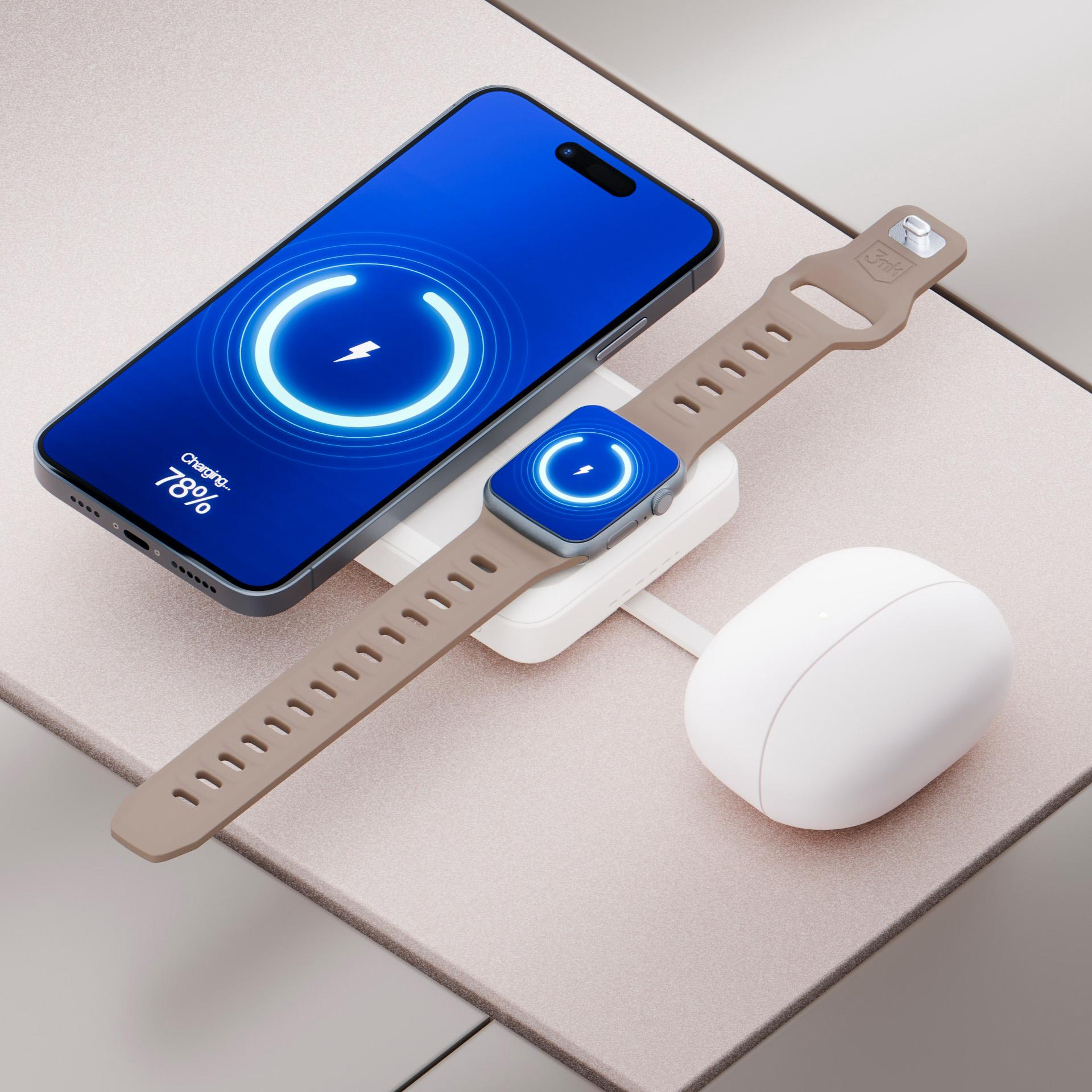 Smartfon, smartwatch i słuchawki ładujące się na białej stacji ładującej.