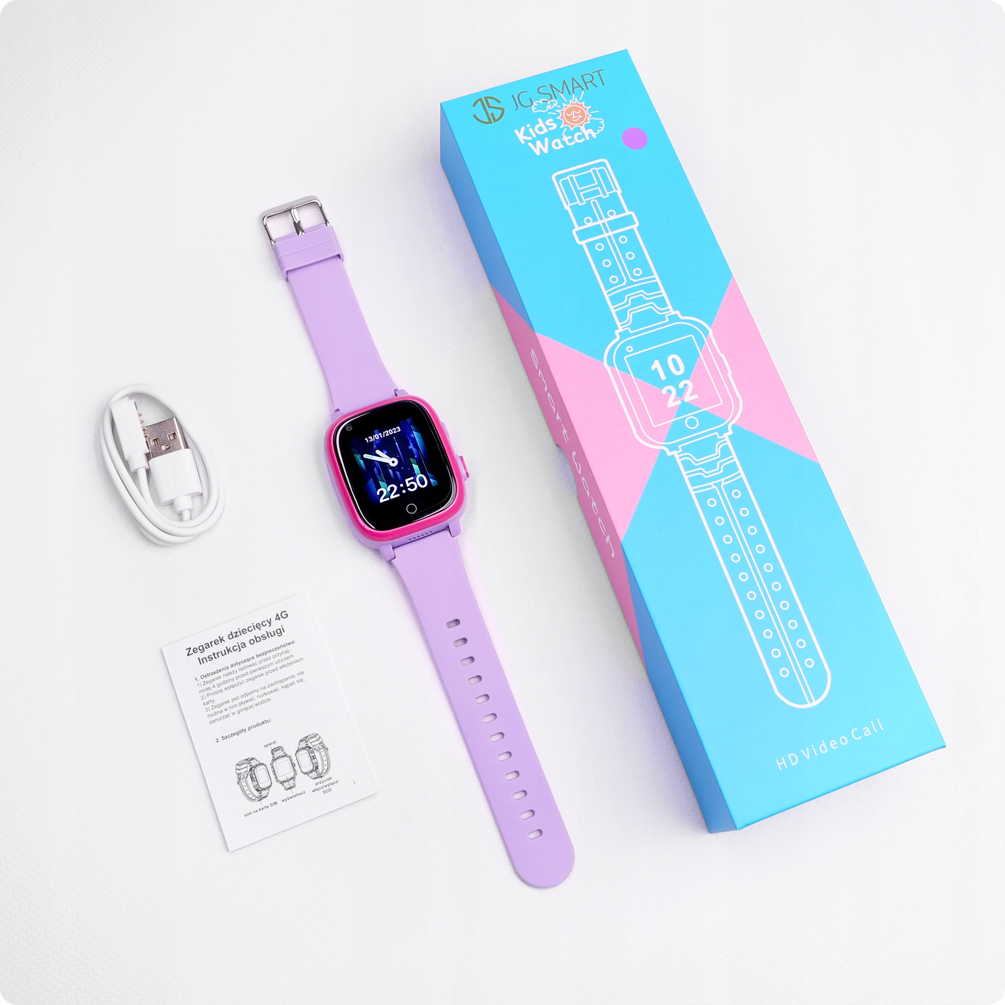 Fioletowy smartwatch z różowymi akcentami, kablem ładującym i instrukcją obok pudełka.