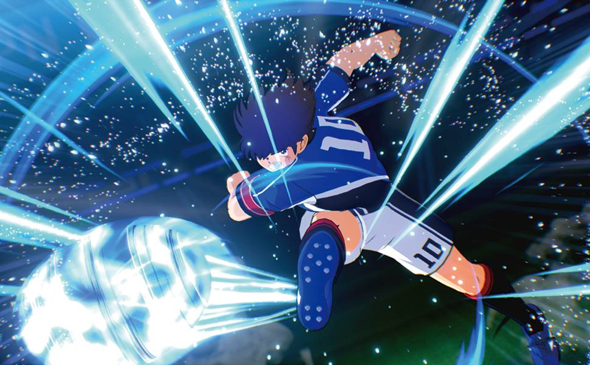 Un calciatore in maglia blu calcia un pallone luminoso.