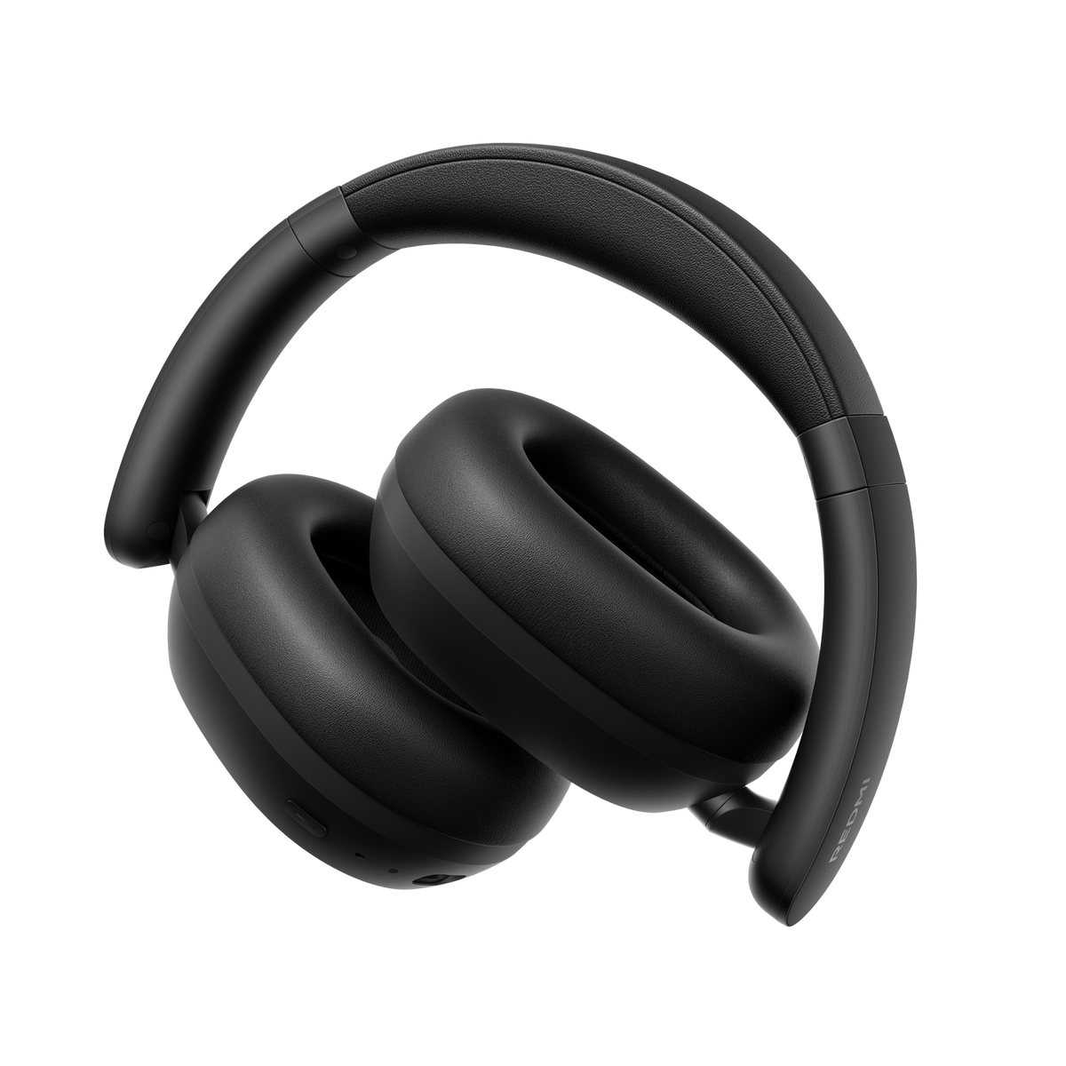 Auriculares negros con almohadillas y diadema acolchadas, sobre fondo negro.