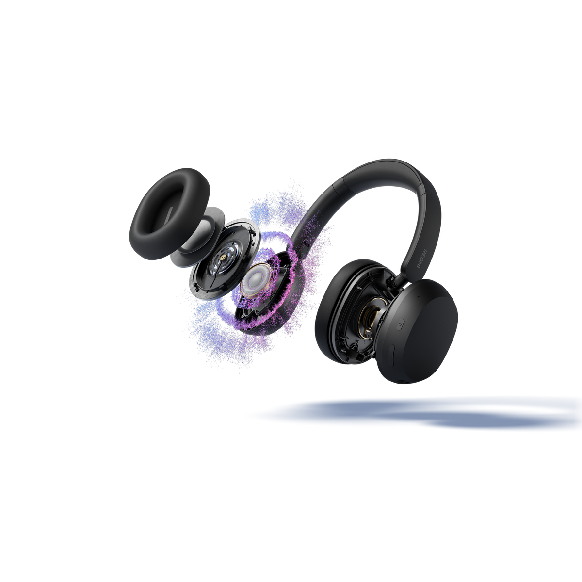 Auriculares negros con partes explotando y partículas coloridas.
