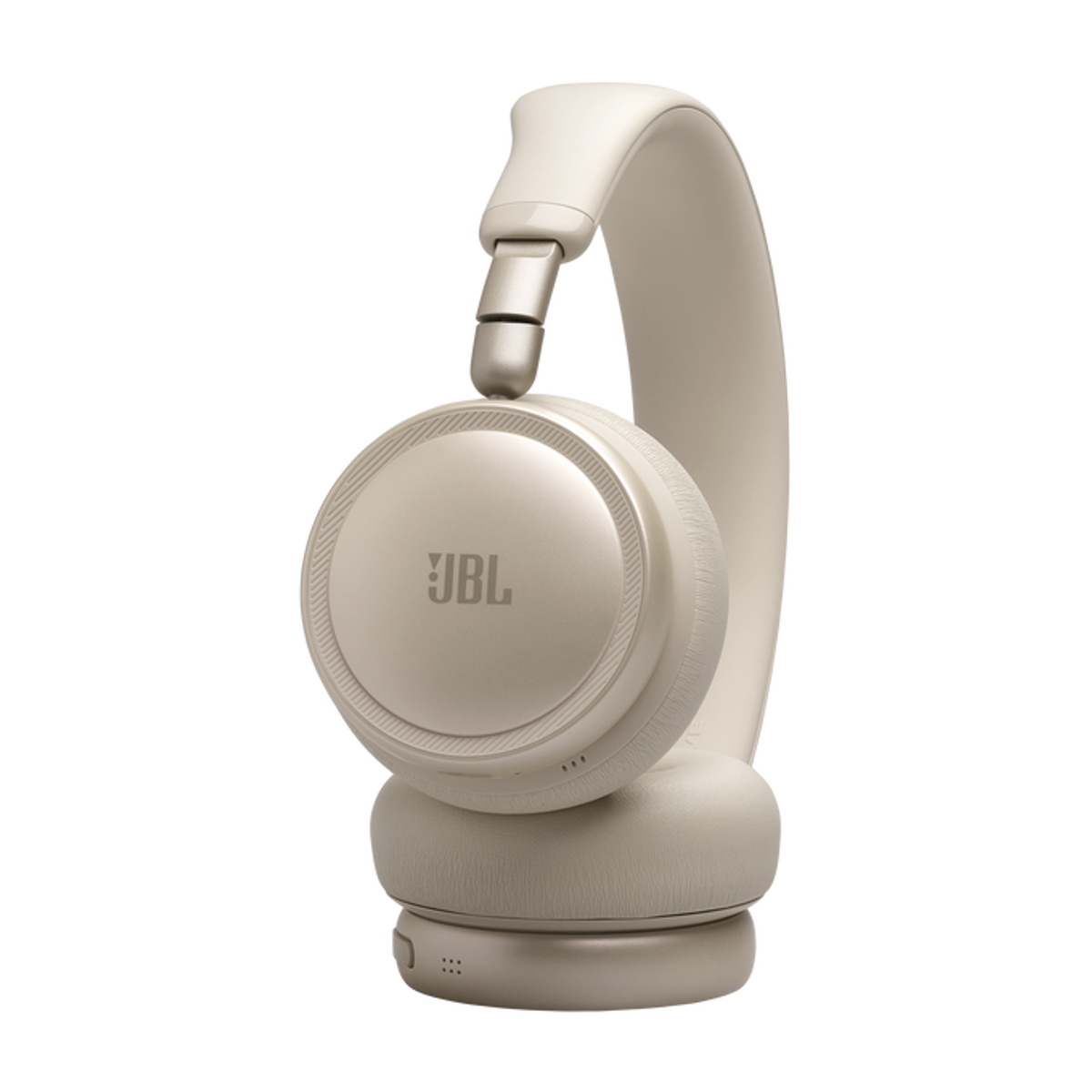 Un paio di cuffie JBL beige con archetto, su sfondo nero.