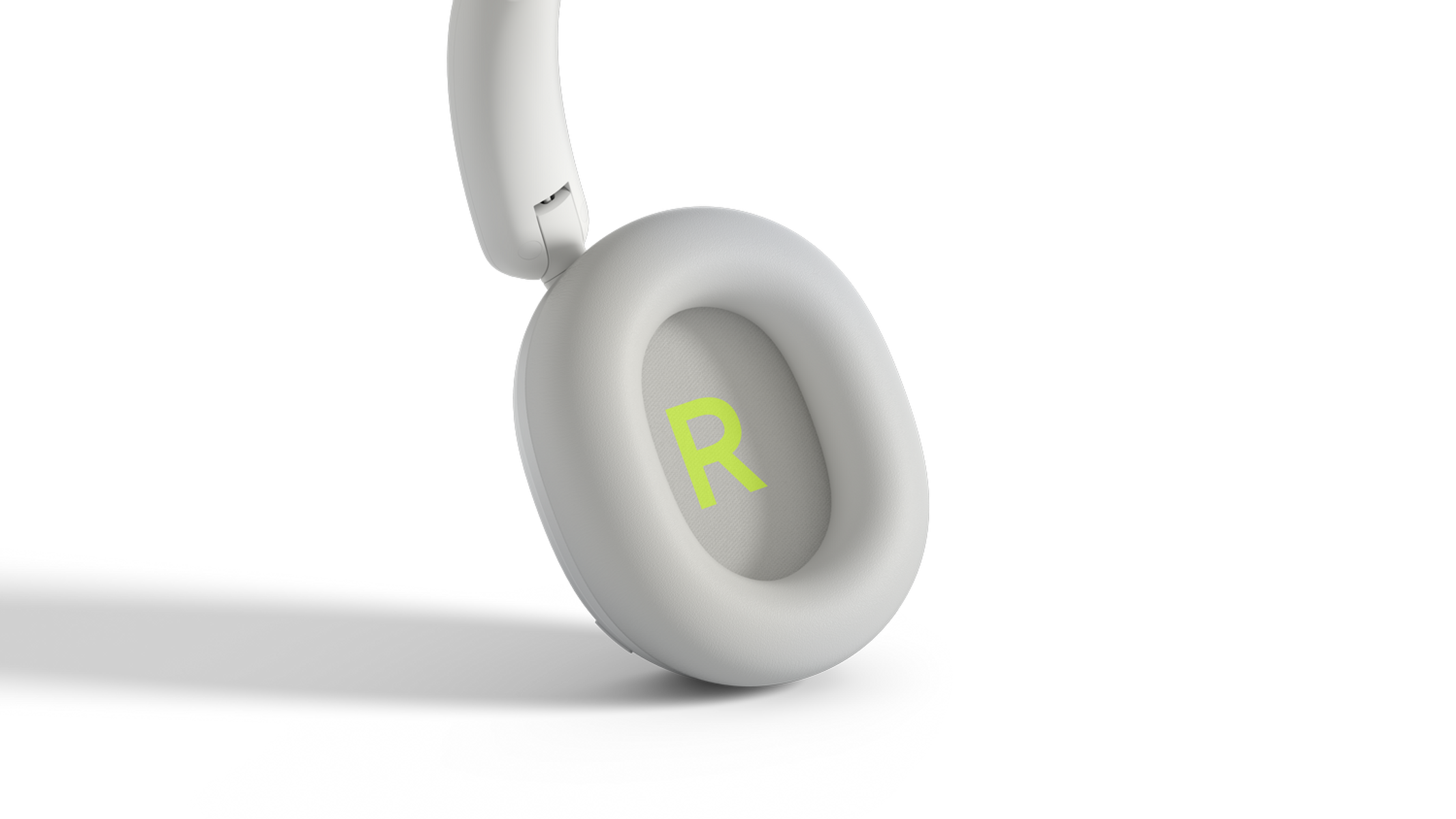 Auricular blanco con símbolo R verde sobre fondo negro.