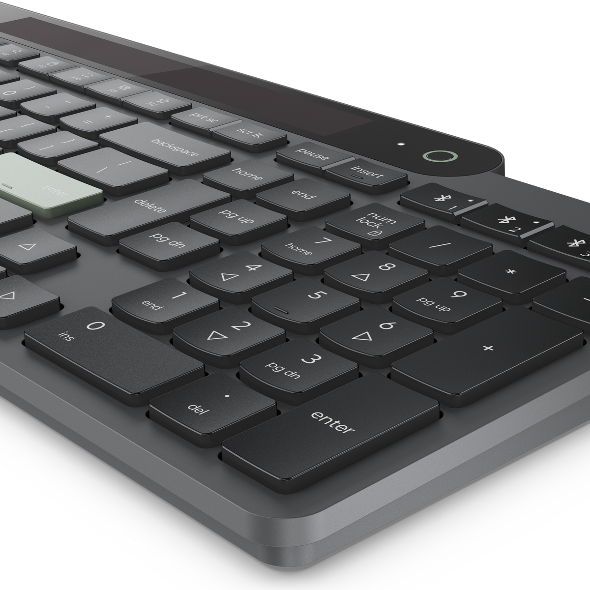 Un primer plano de un teclado oscuro con una tecla Intro verde claro.