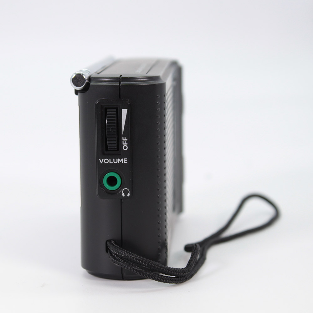 Black portable radio with volume dial, headphone jack, and attached wrist strap.