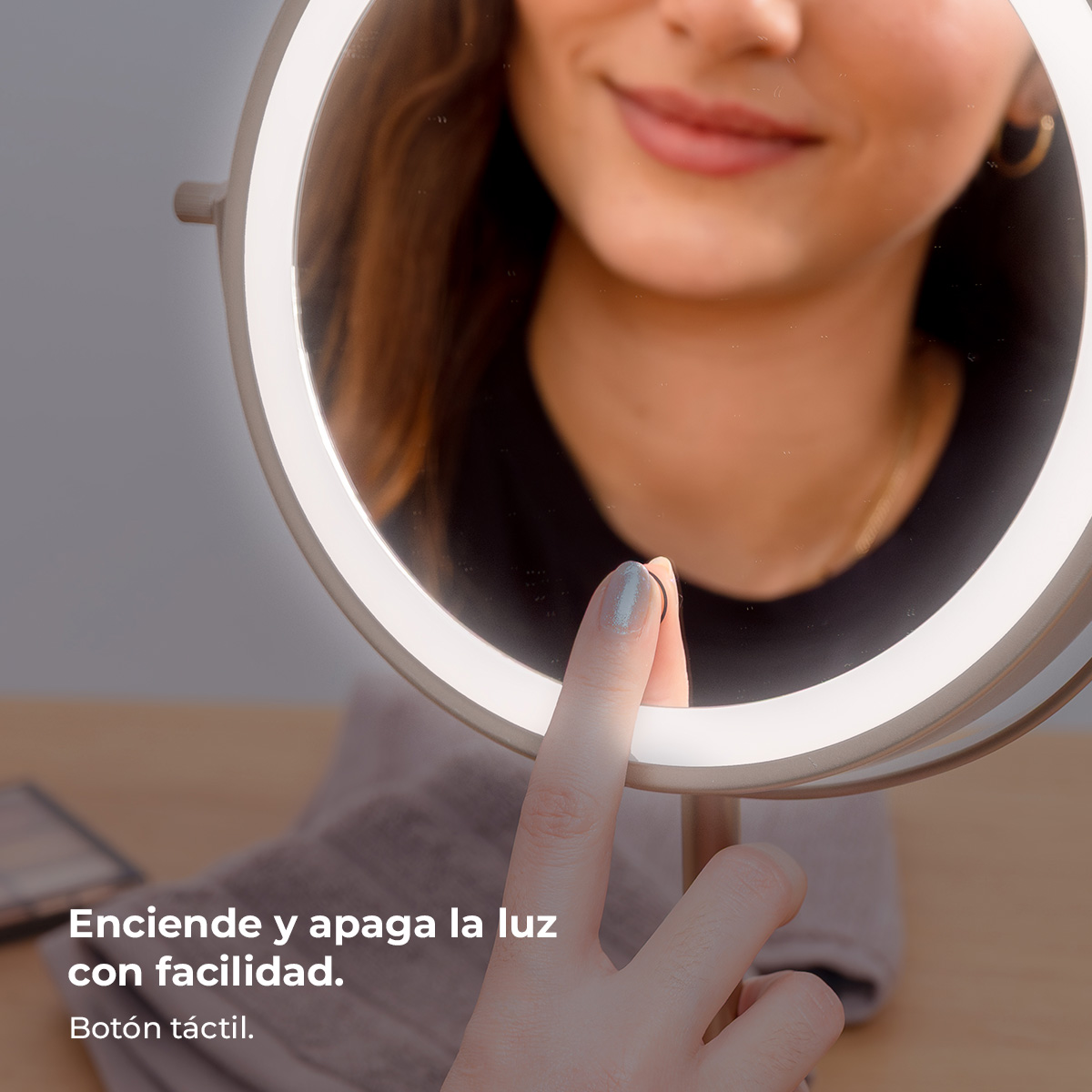 Una mujer toca un espejo iluminado para encender o apagar la luz.