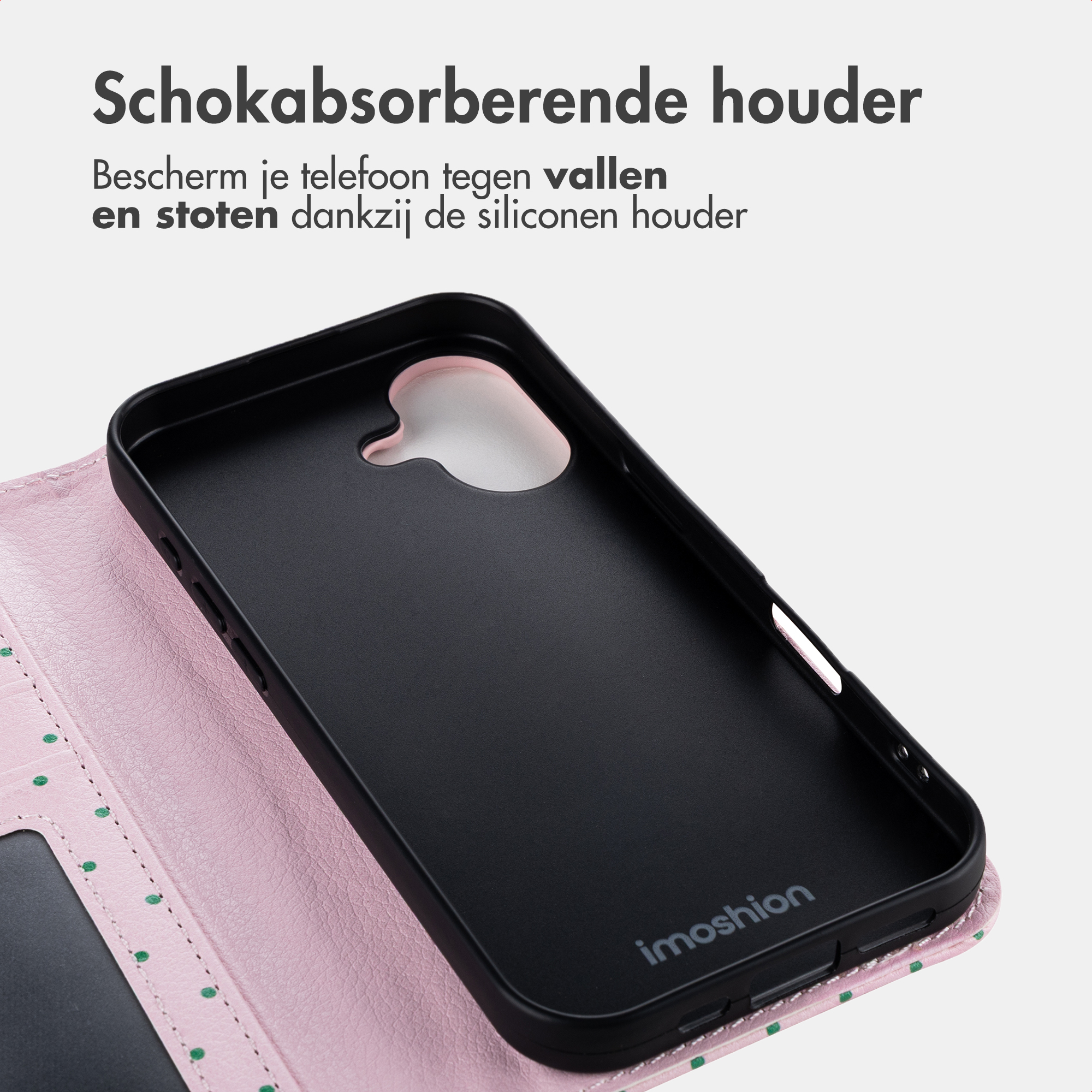 Ein rosa Handyhülle mit grünen Punkten und einem schwarzen Innenteil.