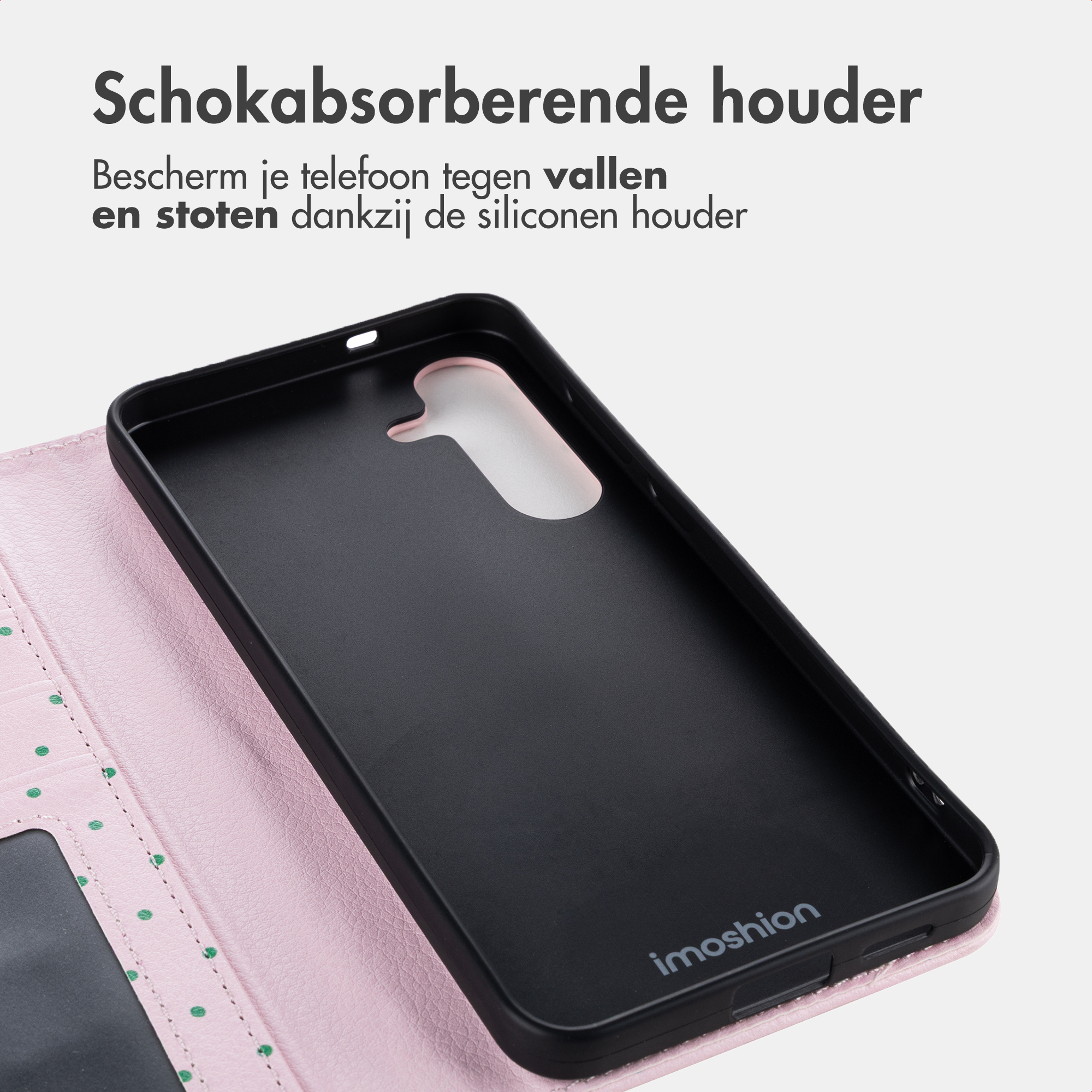 Black phone case on a pink polka dot case.