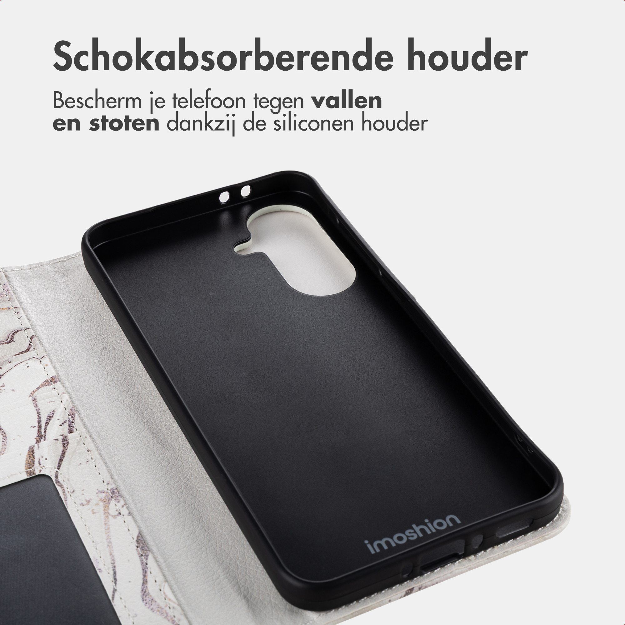 Ein schwarzes Handyhülle-Inlay mit einem marmorierten, weißen Klappdeckel.