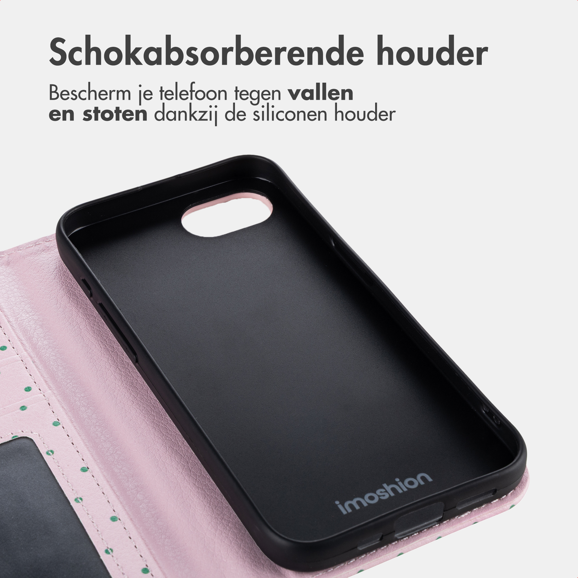 Black phone case with pink interior and green polka dots.