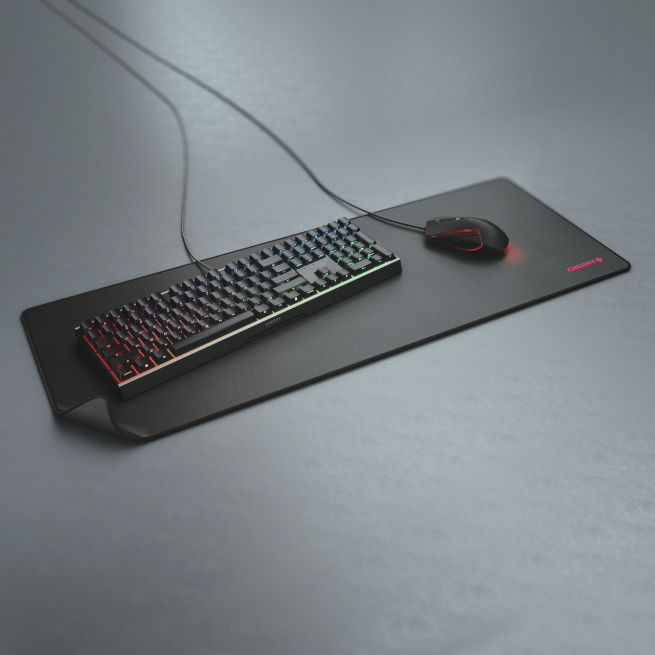 Clavier et souris Cherry noirs sur tapis noir avec éclairage RVB.