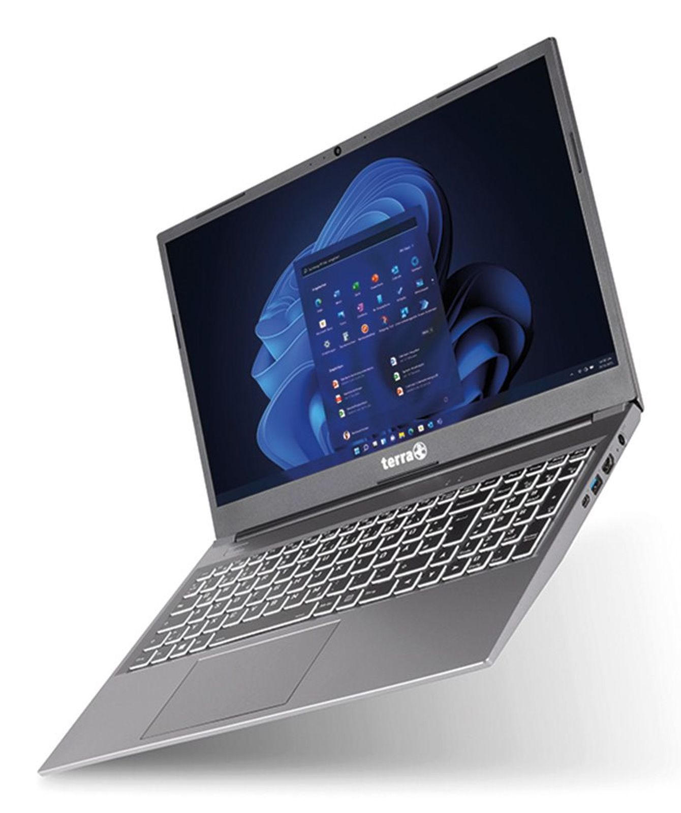 Szary laptop Terra z podświetlaną klawiaturą i ekranem startowym Windows.
