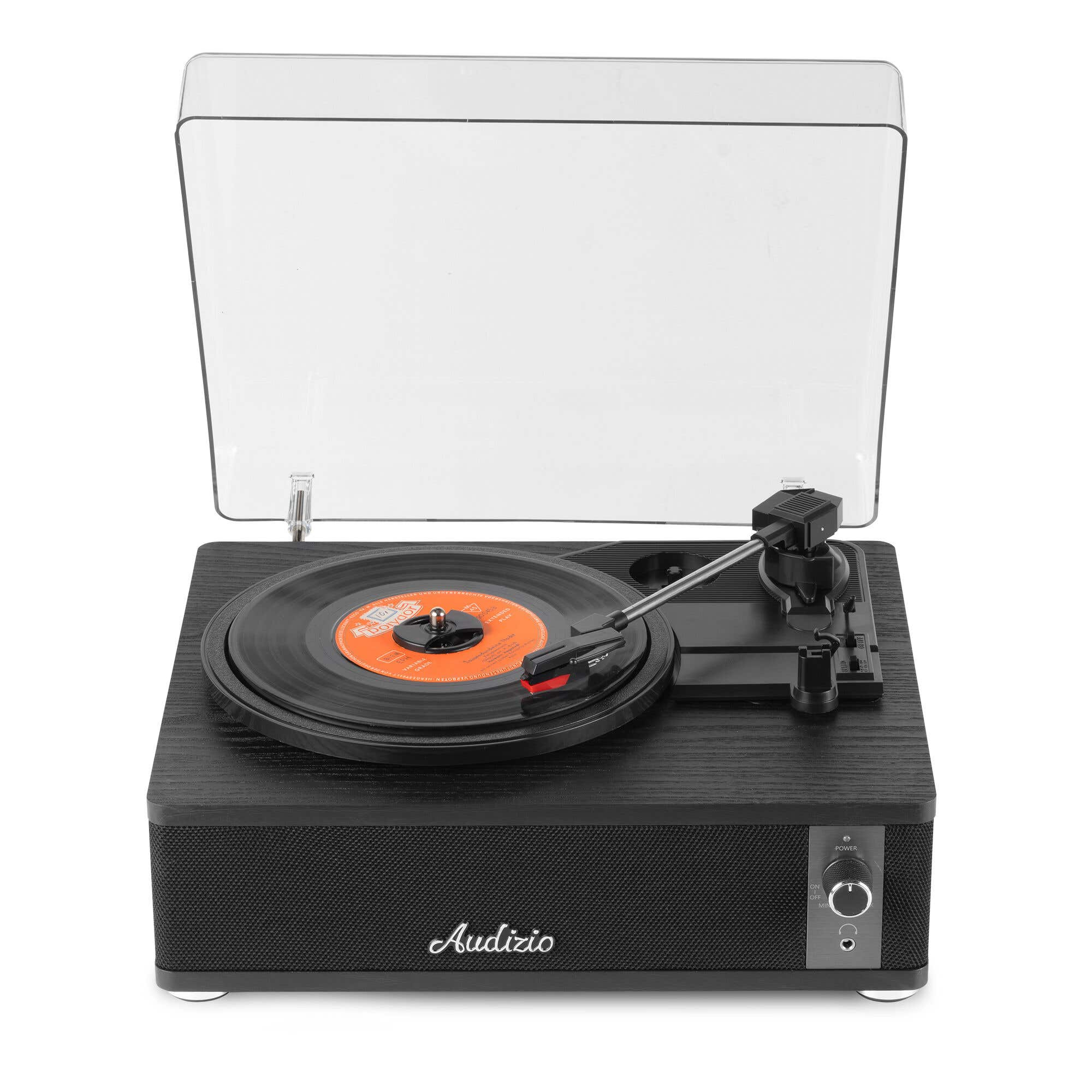 Tocadiscos negro con disco de vinilo, brazo de tono y tapa transparente.
