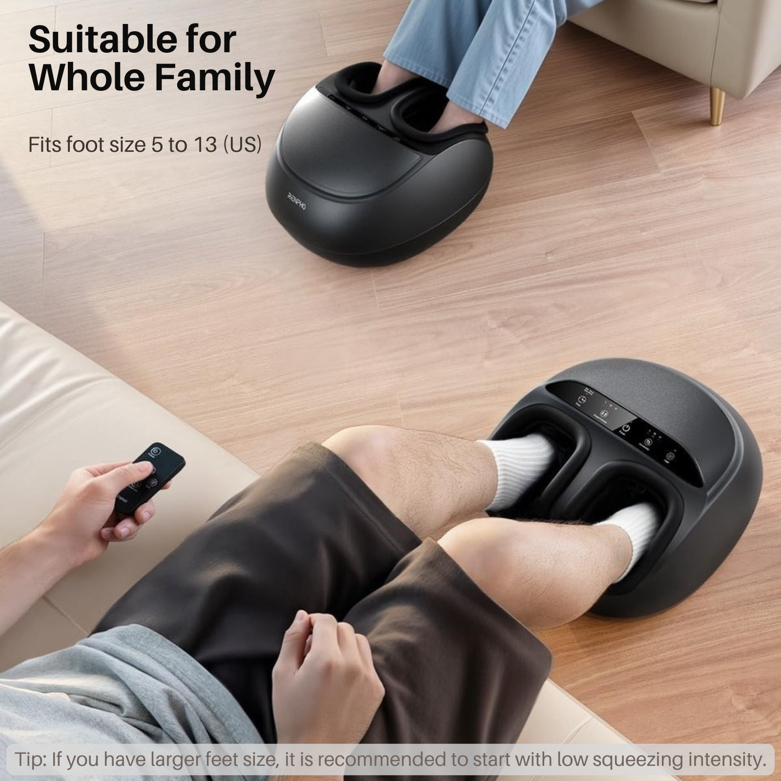A man uses a black foot massager. Another sits on a sofa.