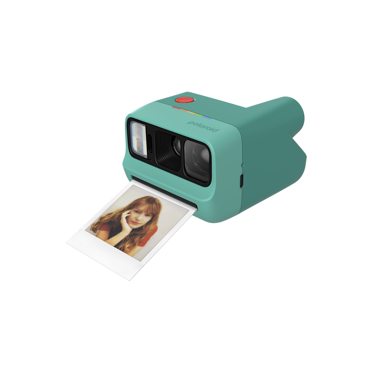 Eine türkise Sofortbildkamera mit einem roten Auslöser und einem Farbfoto auf schwarzem Hintergrund.