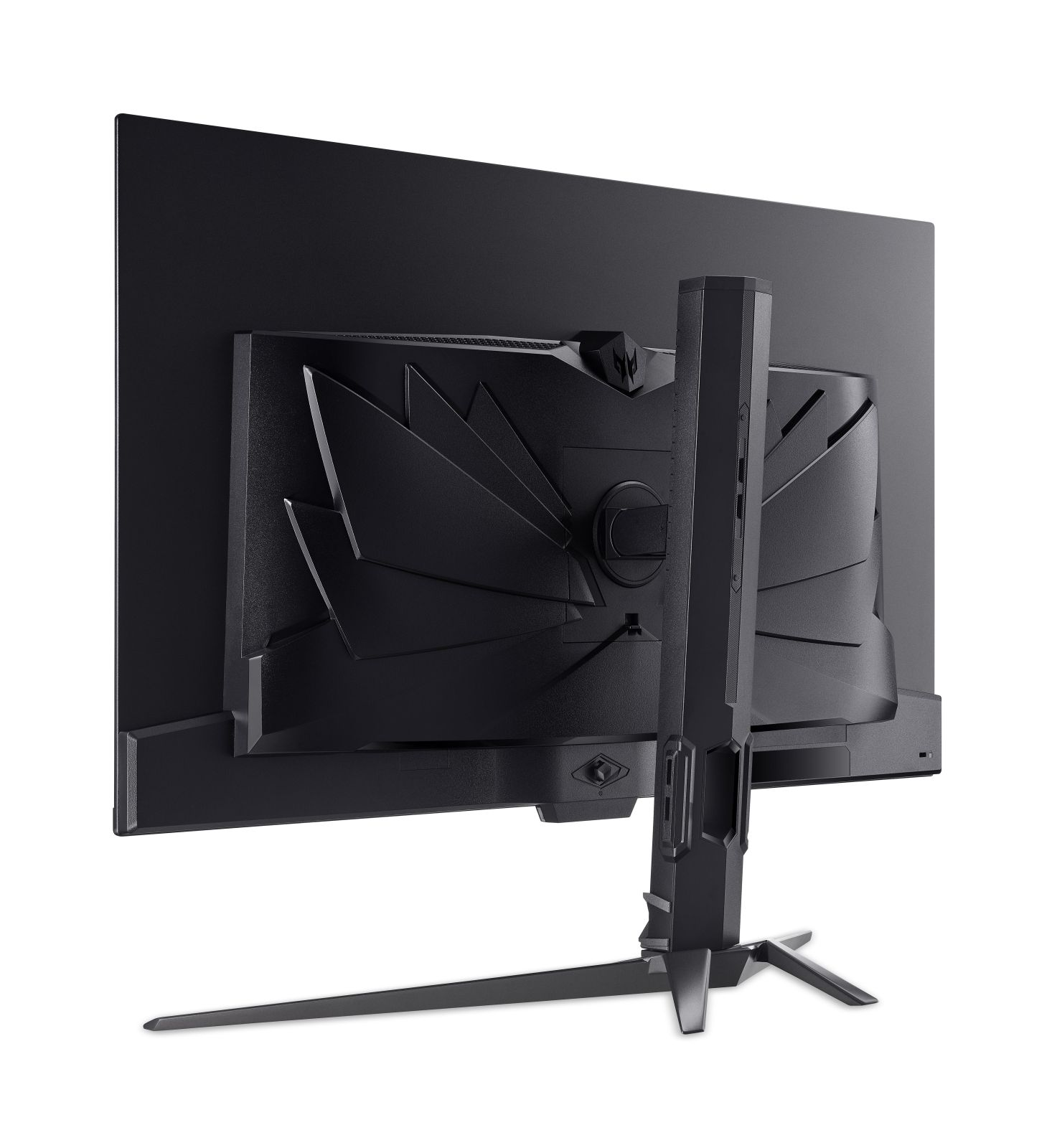 Vista trasera de un monitor negro con un soporte llamativo y un diseño trasero geométrico.