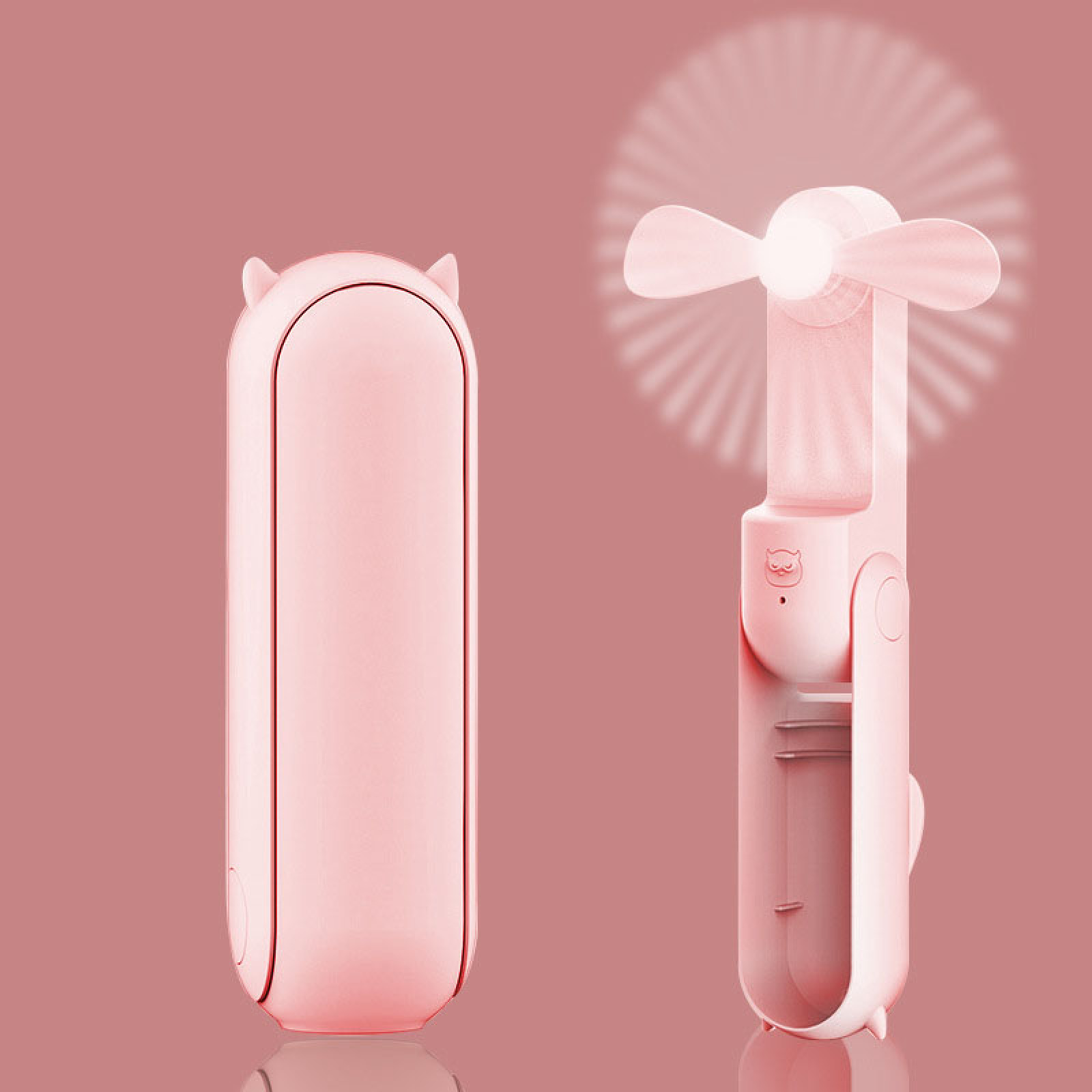 Ein rosa Faltventilator mit Katzenohren, auf einem rosa Hintergrund.