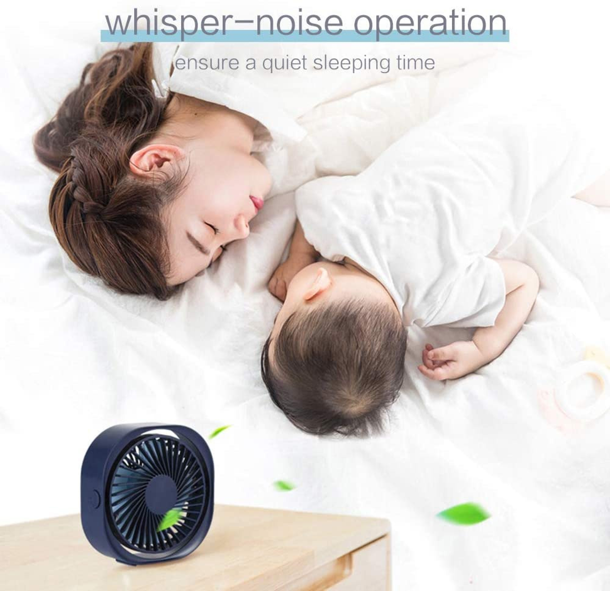 Ein dunkler Ventilator auf einem Holztisch neben einem schlafenden Baby und einer Frau.