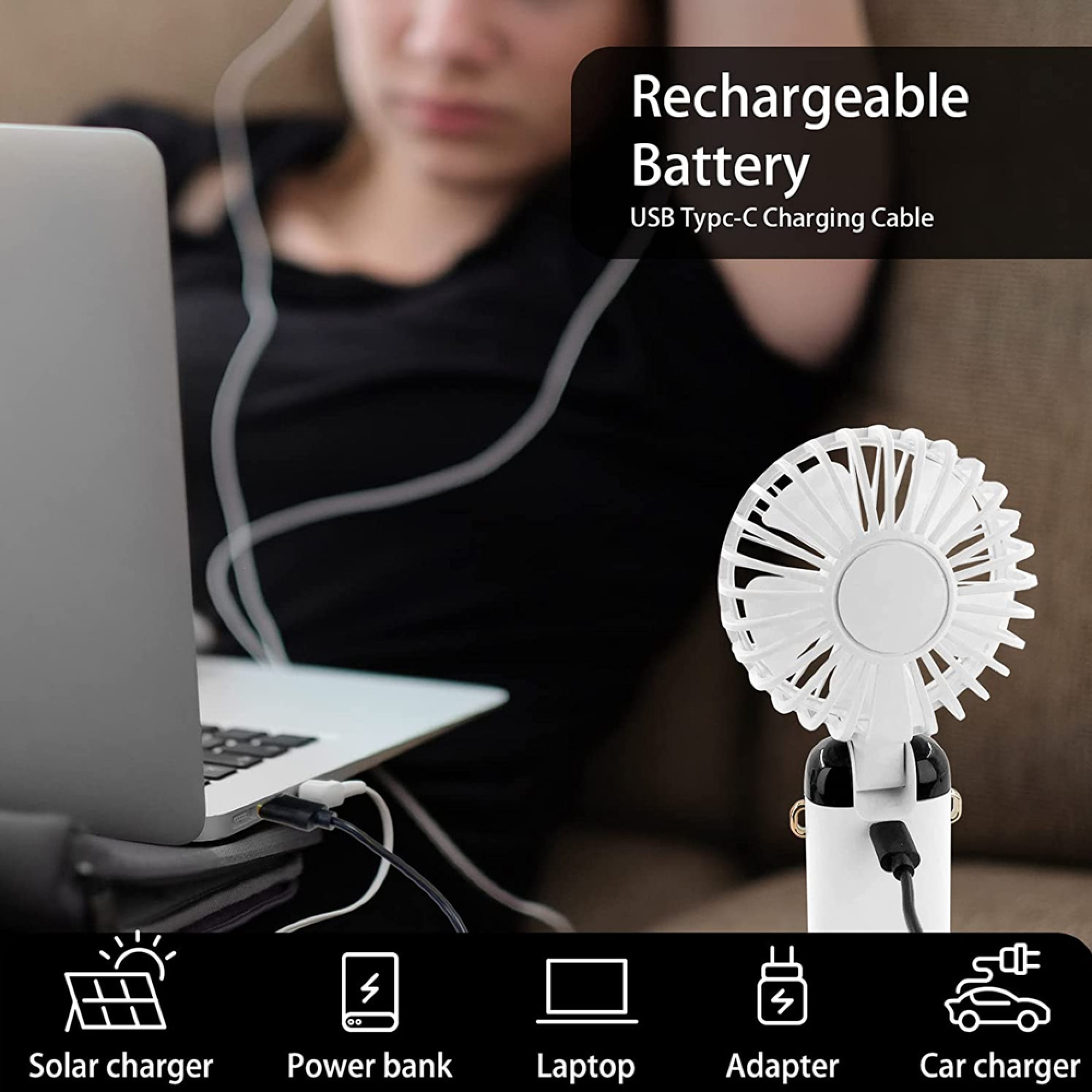Ein Laptop wird über ein USB-C-Kabel aufgeladen, daneben ein kleiner weißer Ventilator.