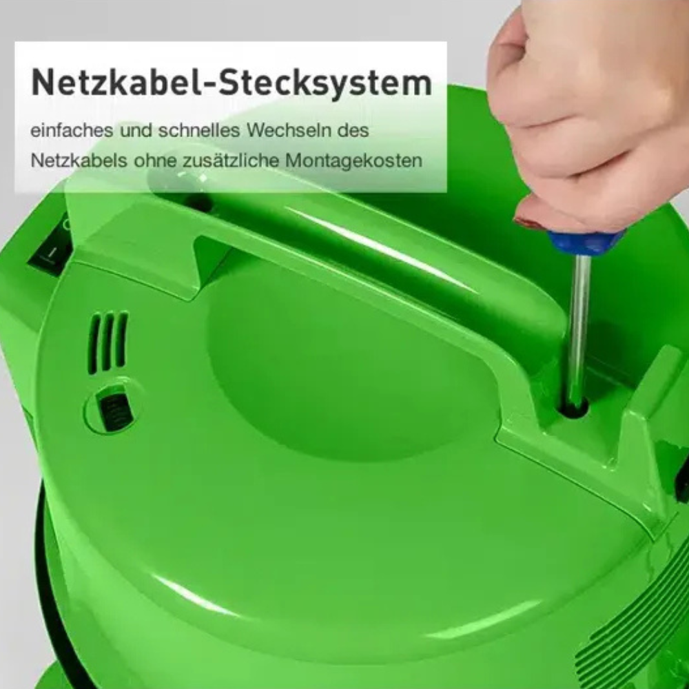 Eine Hand schraubt mit einem Schraubendreher an einem grünen Gerät.