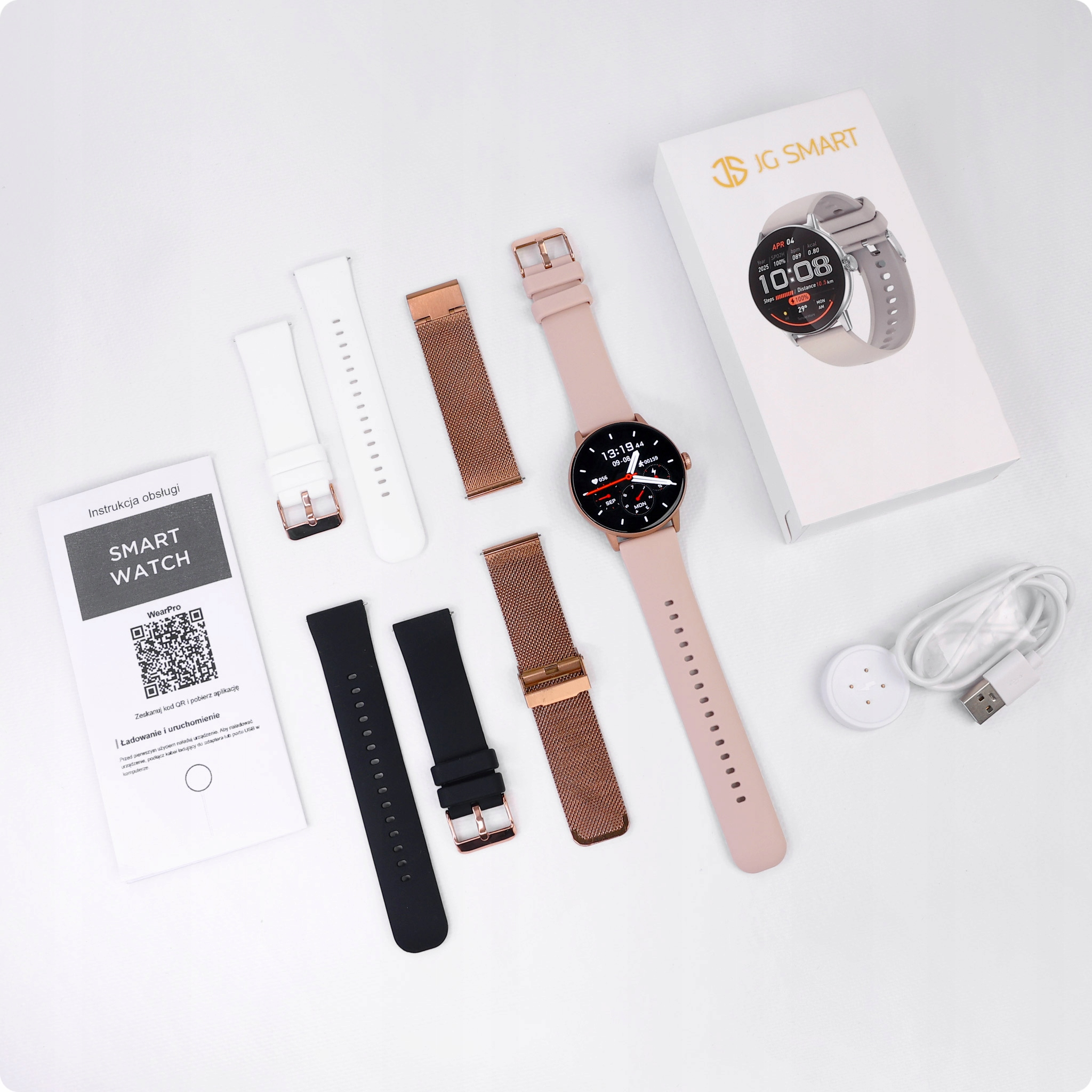 Zestaw smartwatch z różową bransoletą, zapasowymi bransoletami, kablem i instrukcją.