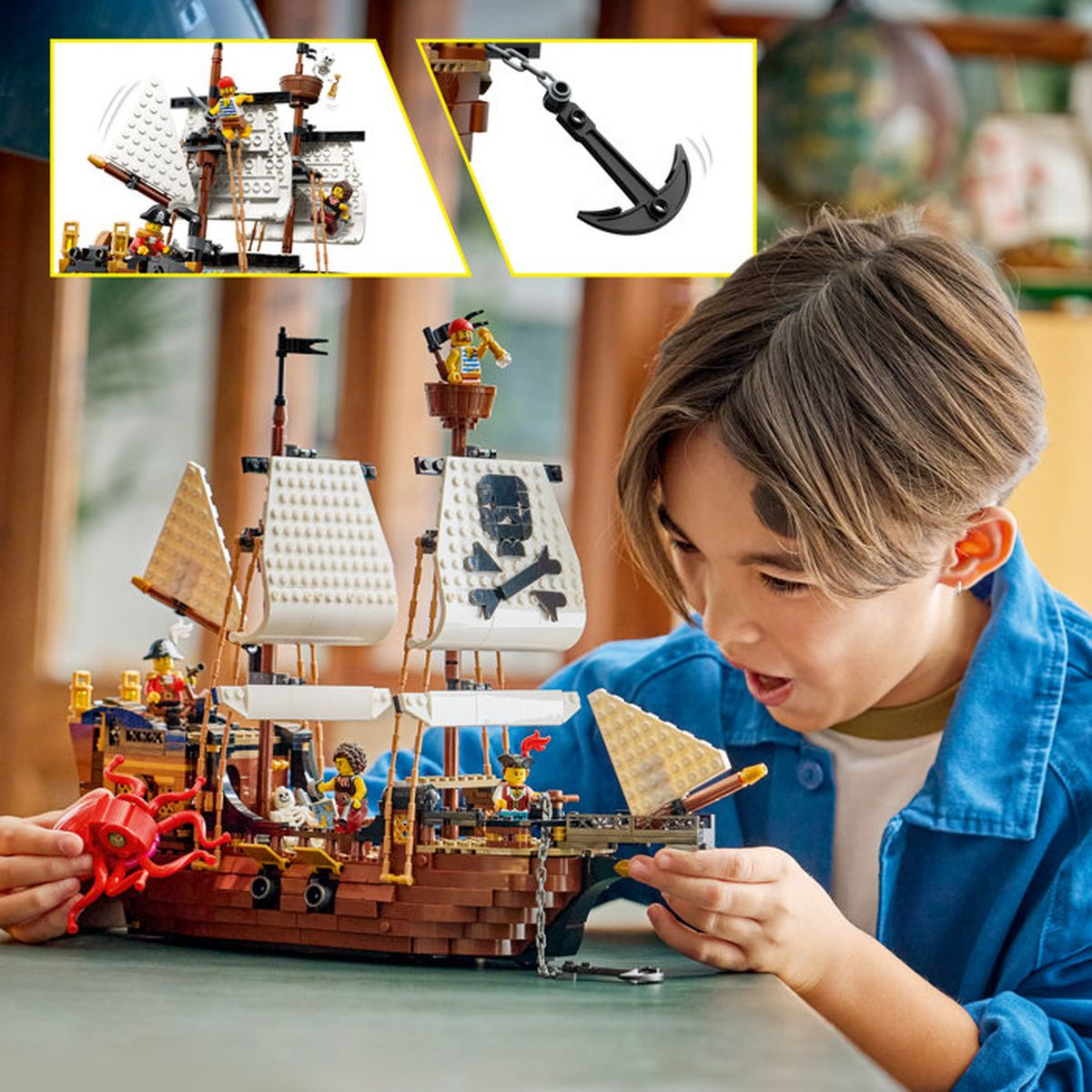 Un niño construye un barco pirata de Lego con ancla y figuras.