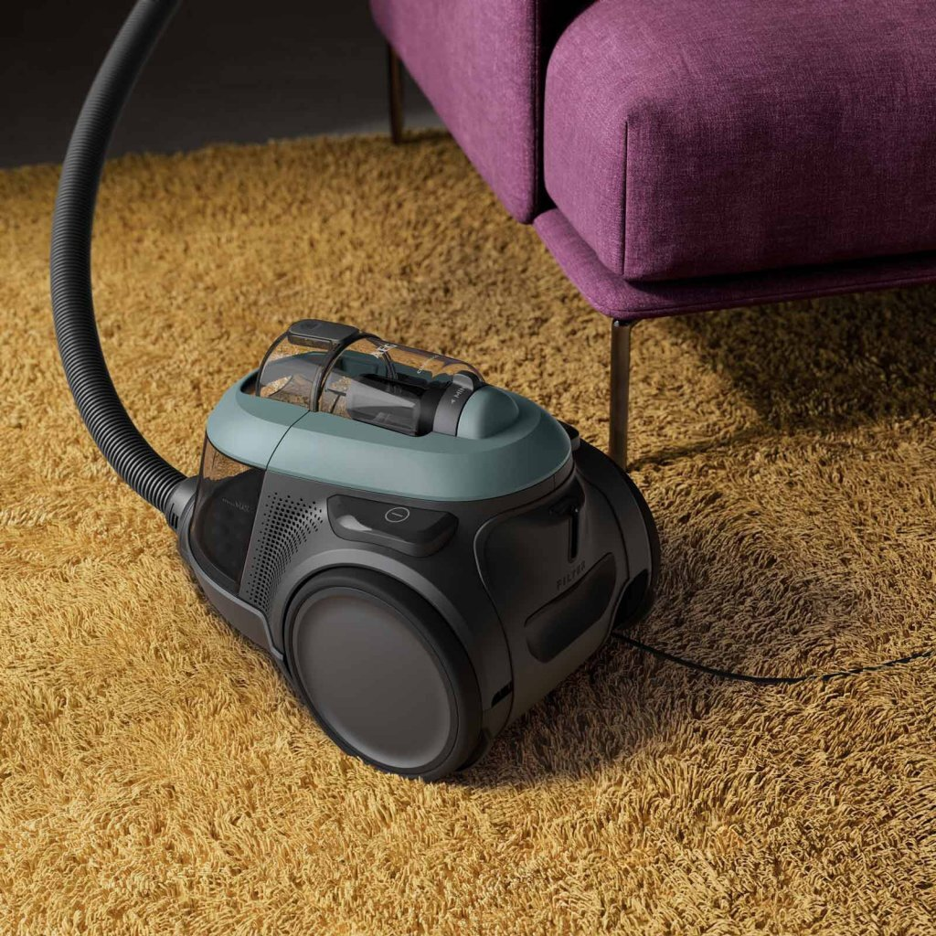 A black vacuum cleaner with teal accents sits on a yellow rug next to a purple sofa.