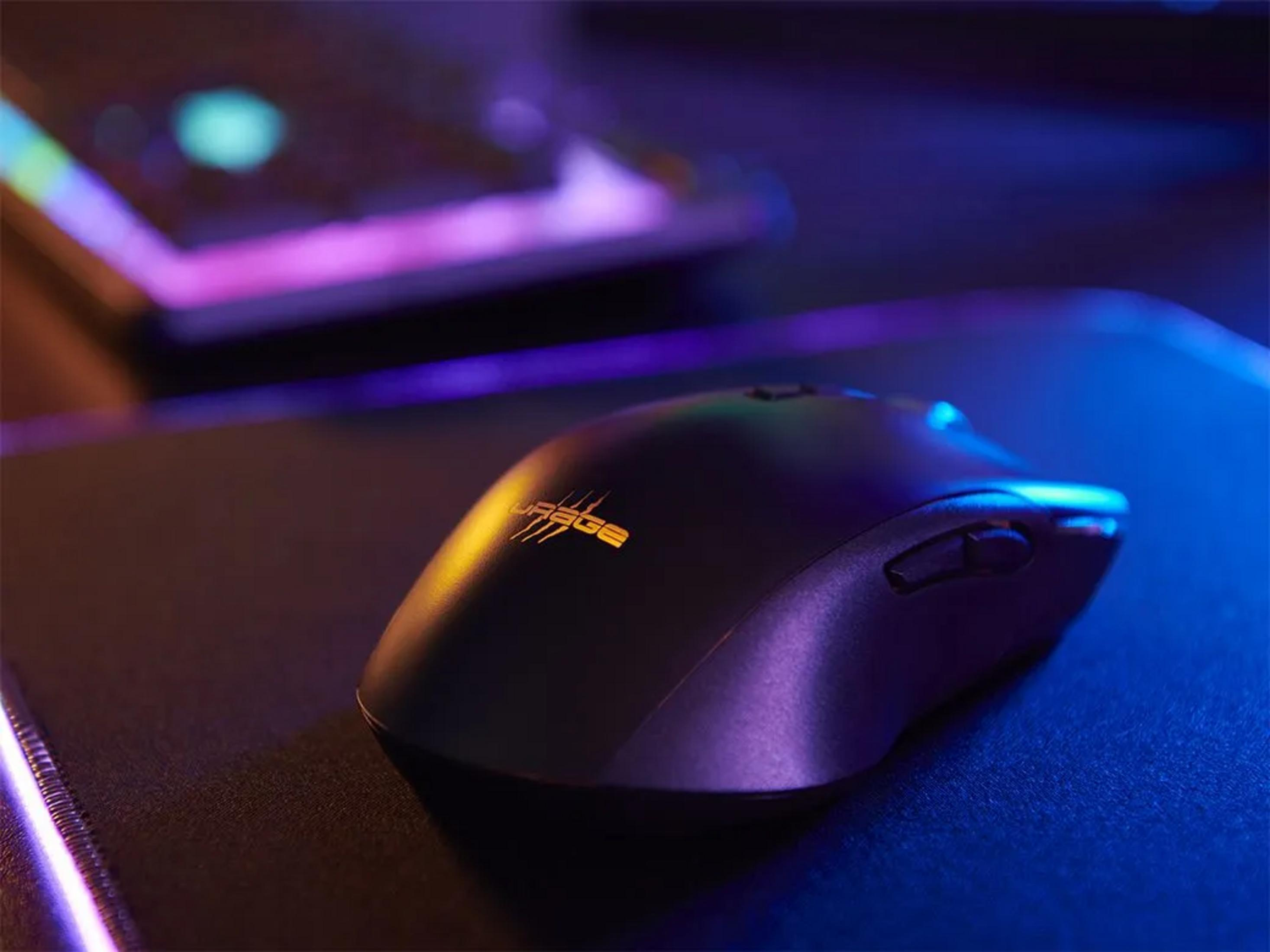Schwarze Gaming-Maus mit orangefarbenem Logo auf einer leuchtenden Unterlage.